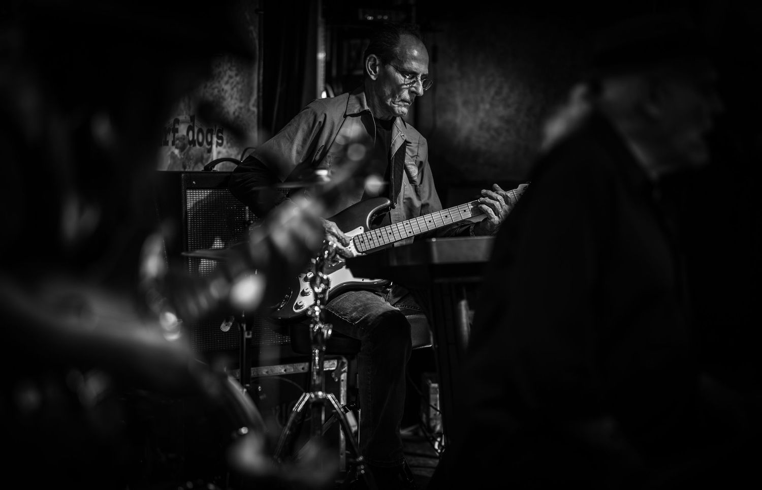 Dark silhouettes of musicians performing on stage.