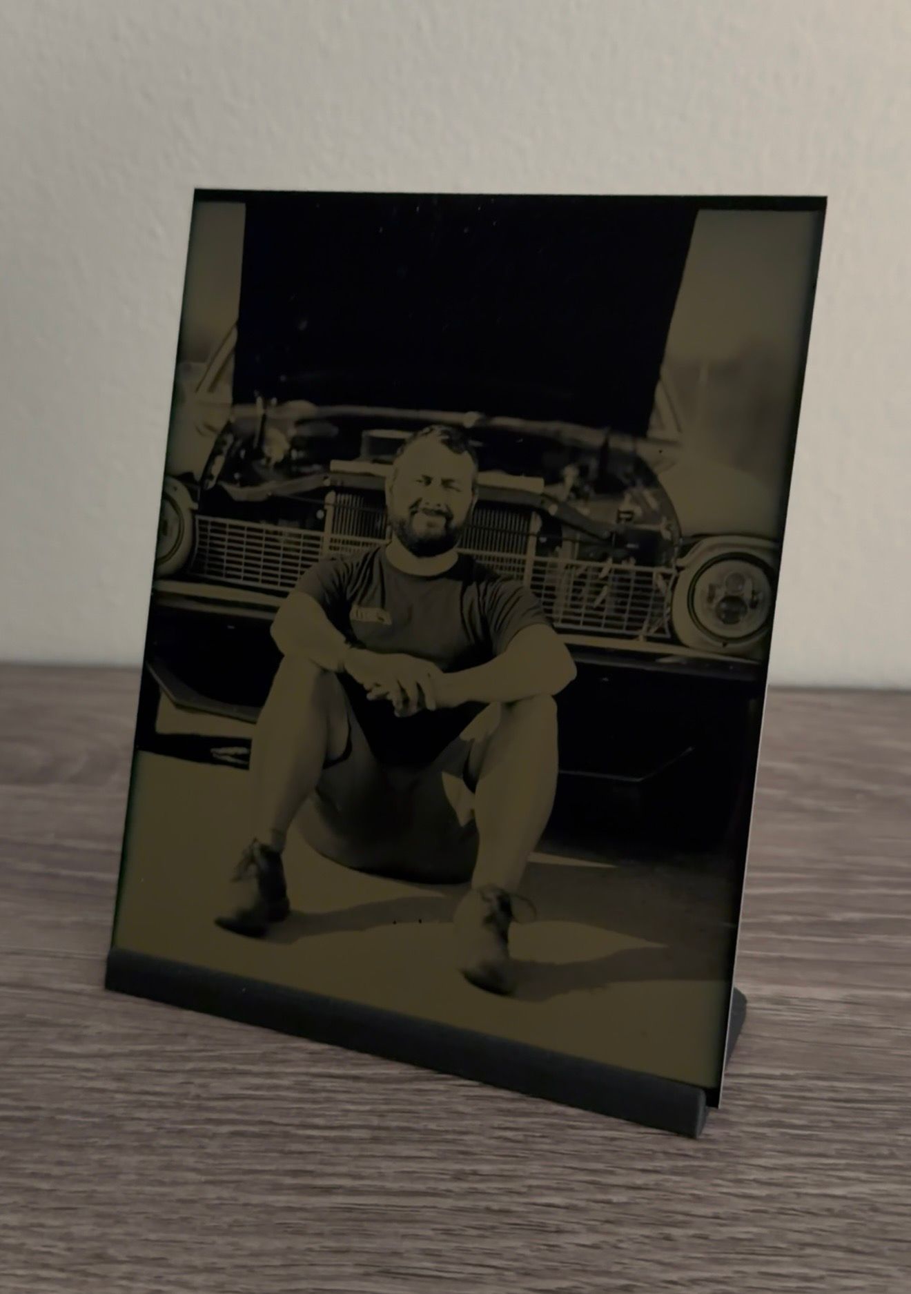 Vintage sepia photographs showing someone posing with a classic 1950s car from different angles.