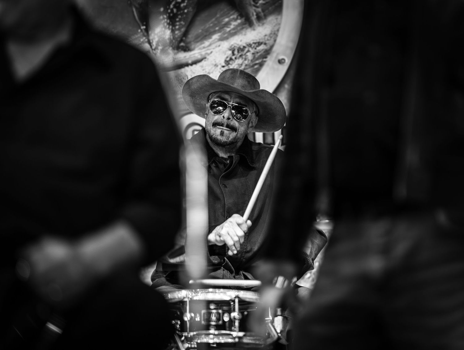 Musicians performing on stage captured in dramatic black and white lighting.