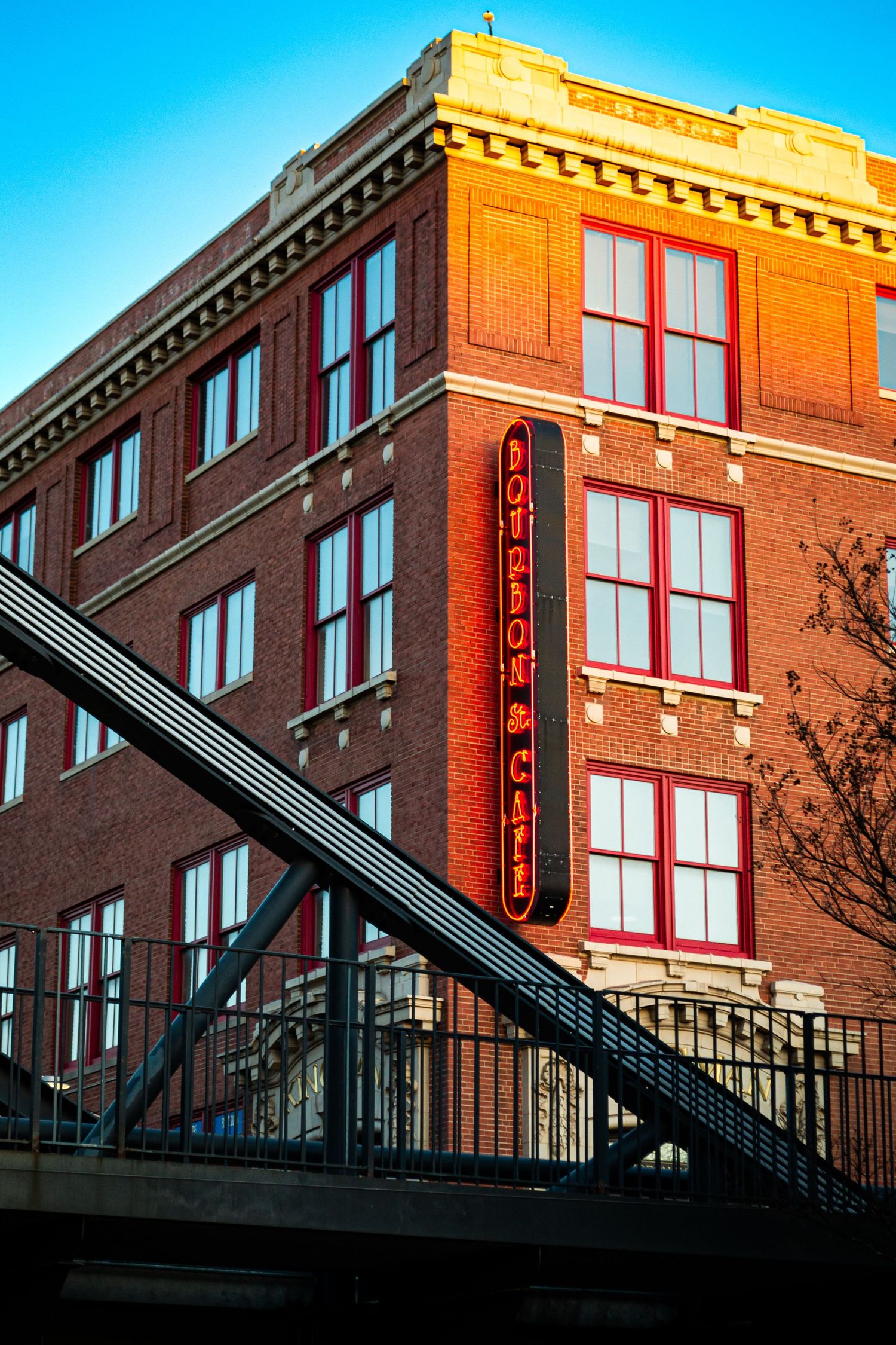 Photo of a building in OKC with a bridge in front.