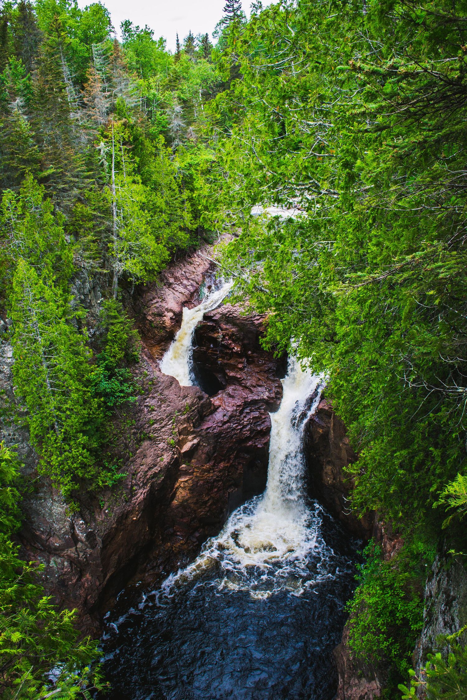 Photo of a waterfall going into the rock.