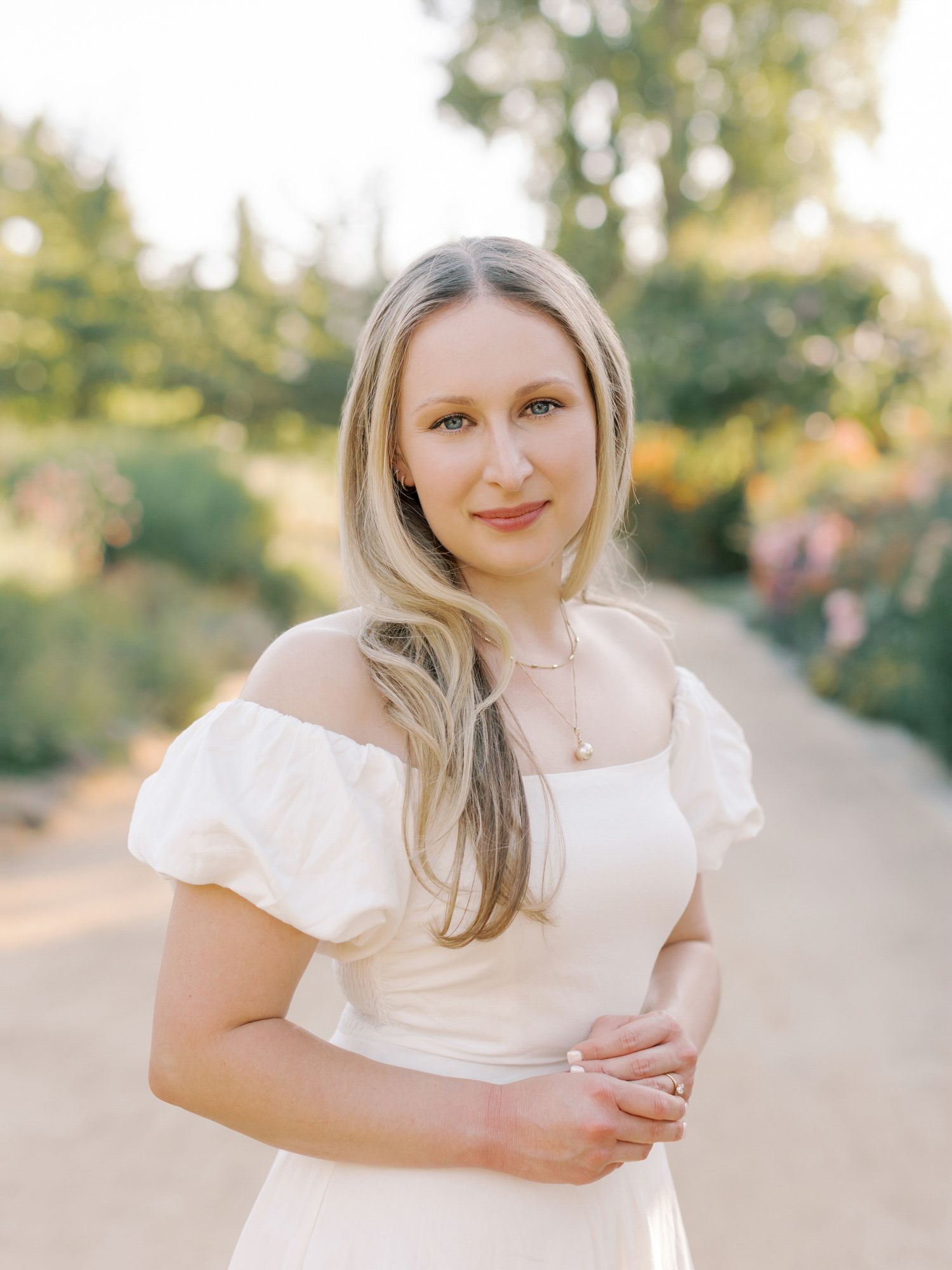 Portrait in a white dress outdoors with soft natural lighting and garden background at Cornerstone Sonoma,