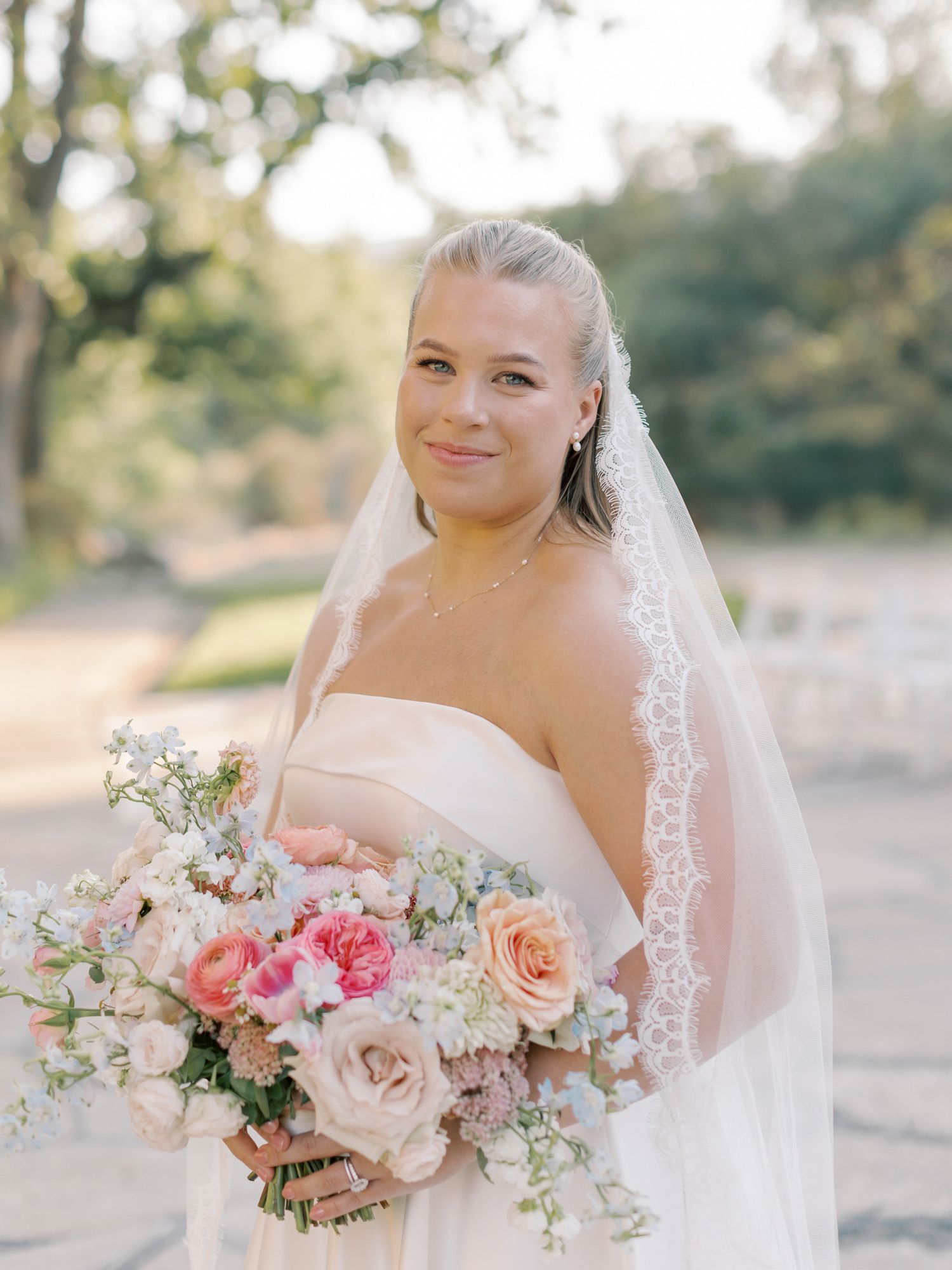 Beautiful bridal portrait showcasing a strapless gown, veil, and romantic pastel bouquet in Napa.