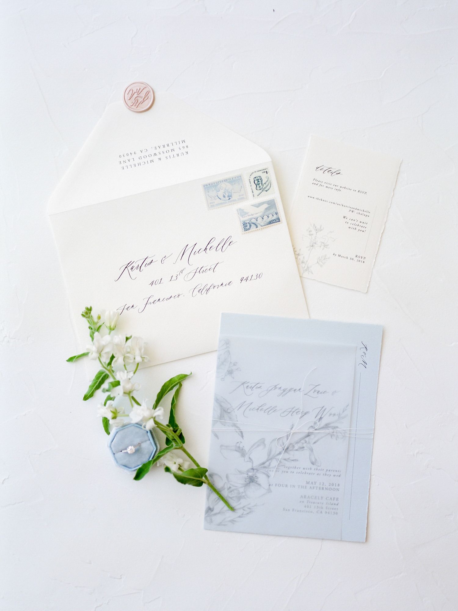 Wedding invitation suite in white and blue with delicate floral accents in Napa.