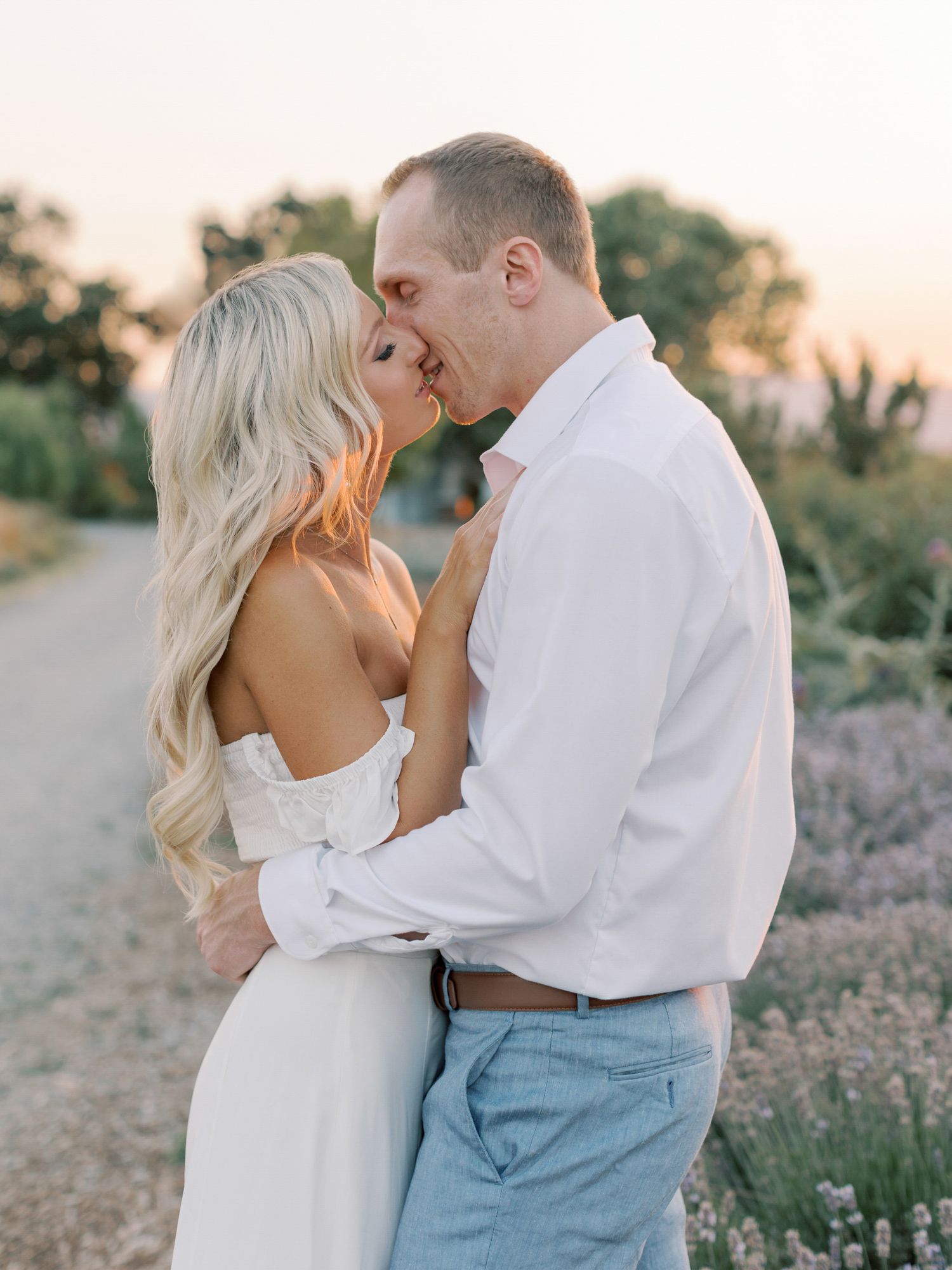Romantic moment captured outdoors during golden hour with natural lavender landscape background at Park Winters.