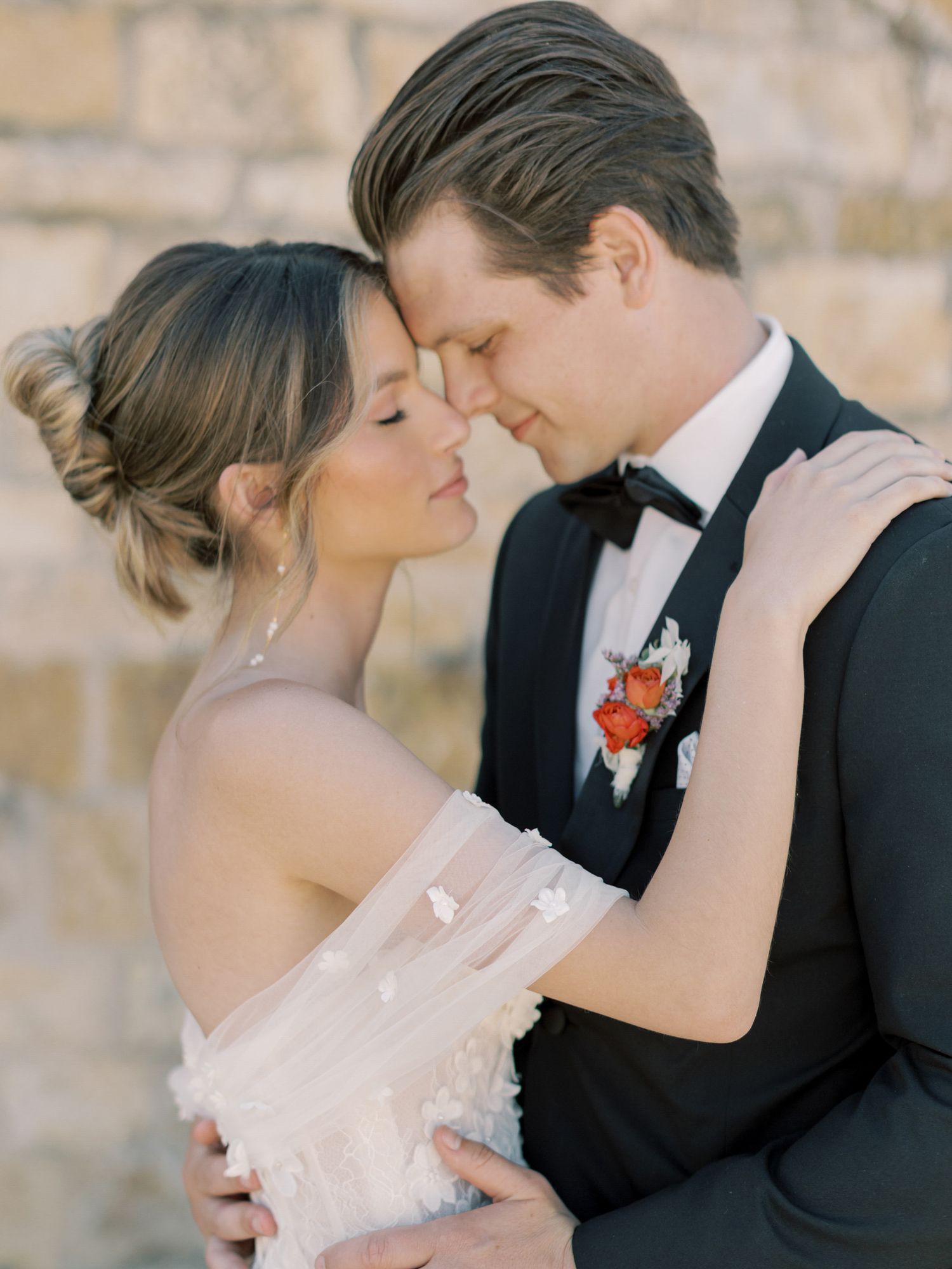 Romantic moment captured between a bride and groom at their wedding at Sunstone Winery in Santa Ynez.