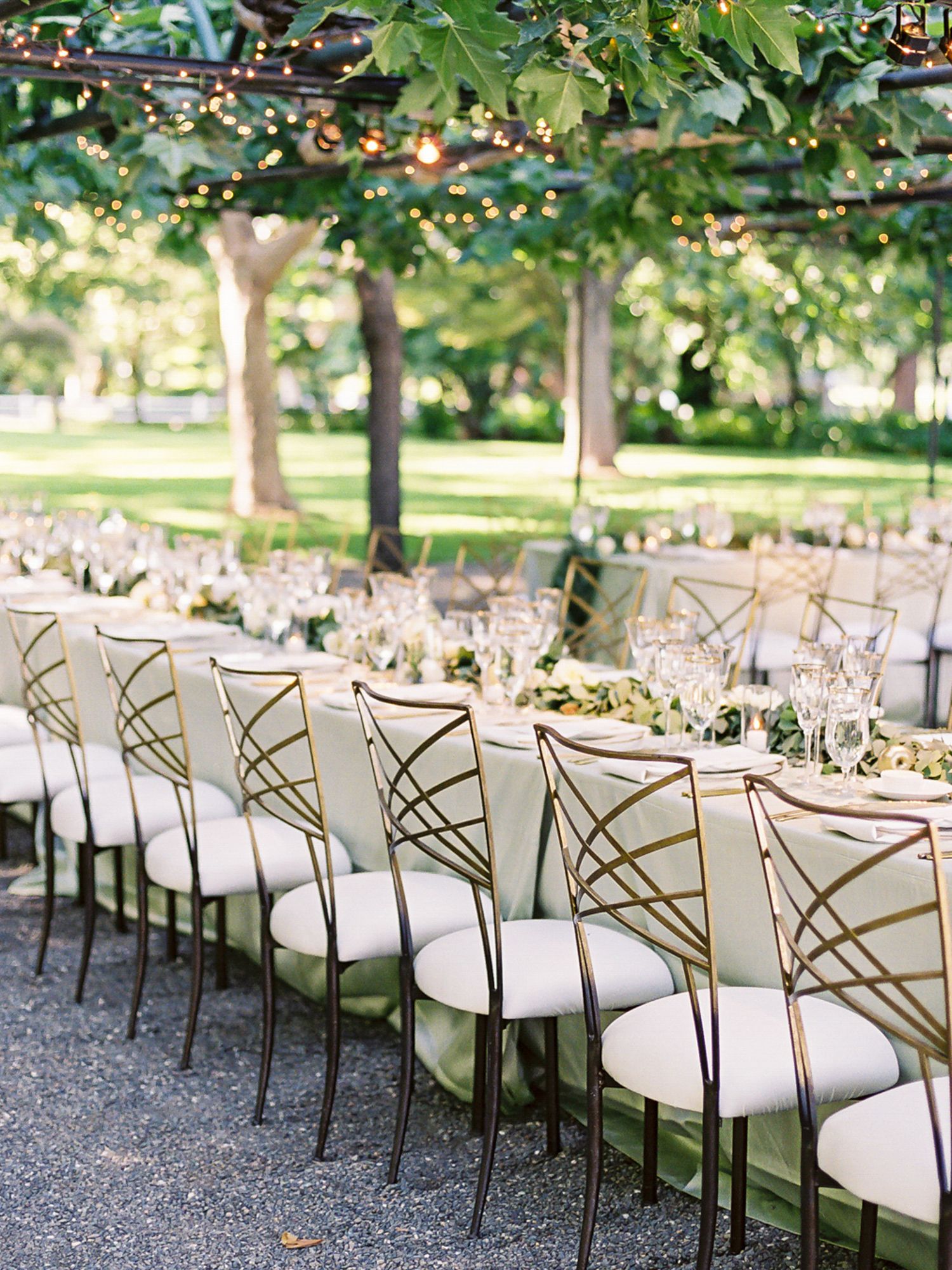 Modern white and gold chairs arranged in rows for outdoor garden wedding at Beaulieu Garden in Rutherford.