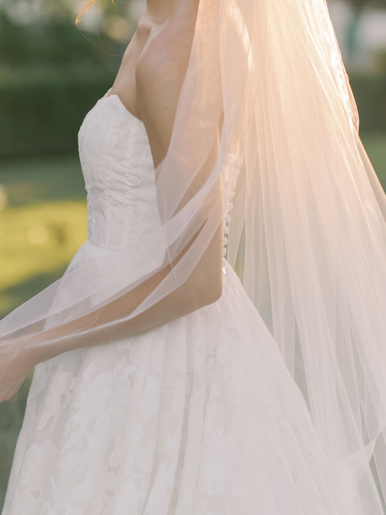 Close-up detail of a flowing white wedding dress with delicate tulle veil in natural light at The General's Daughter in Sonoma.
