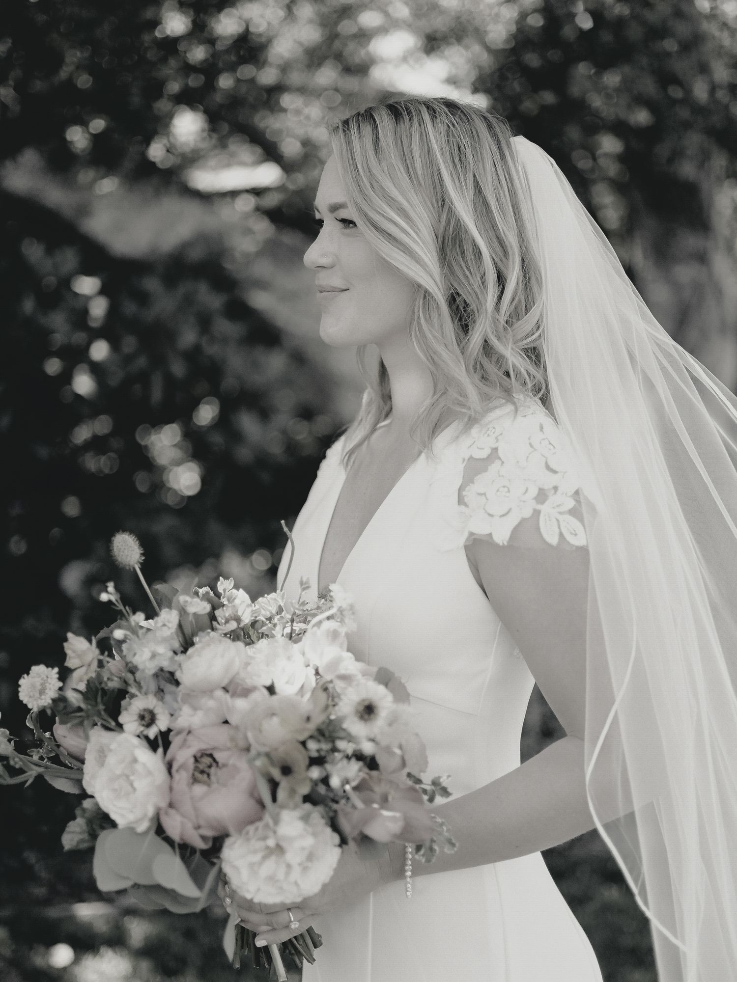 Classic black and white bridal portrait with a flowing bouquet at Thomas Forgarty Winery in Woodside.