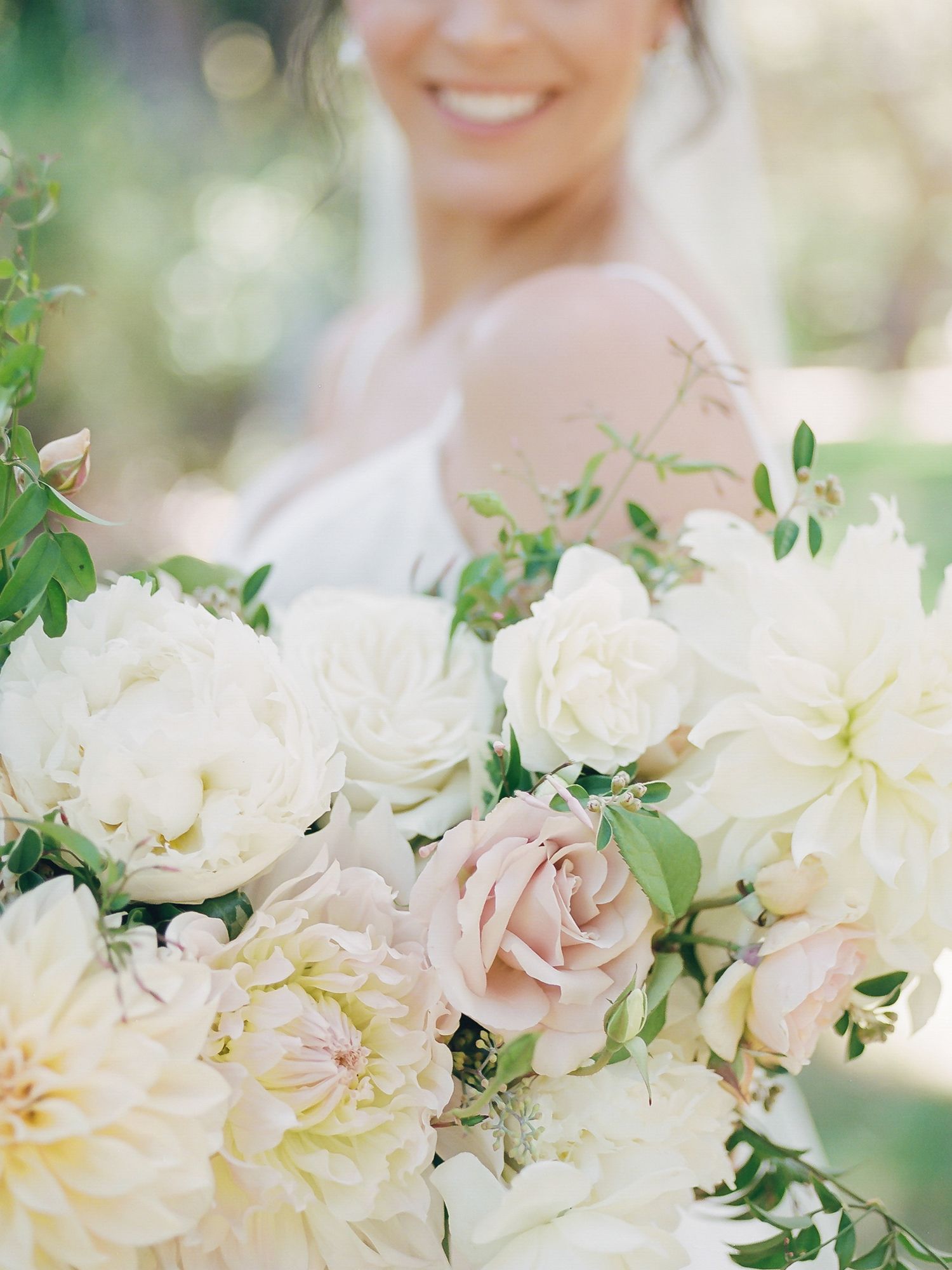Romantic bridal bouquet featuring white peonies and blush roses with delicate greenery at Gardener Ranch in Carmel Valley.
