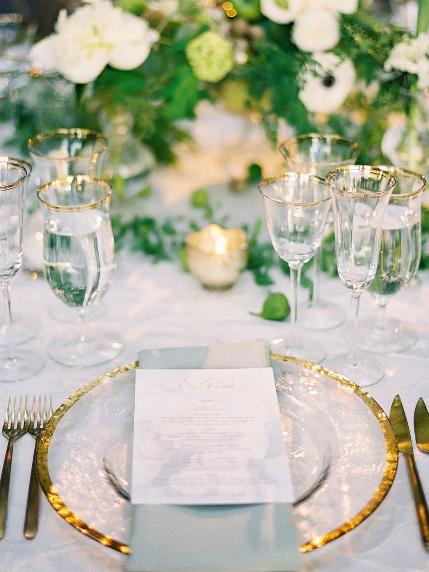 Elegant wedding table setting with gold charger plates and floral centerpieces at Beaulieu Garden in Rutherford.