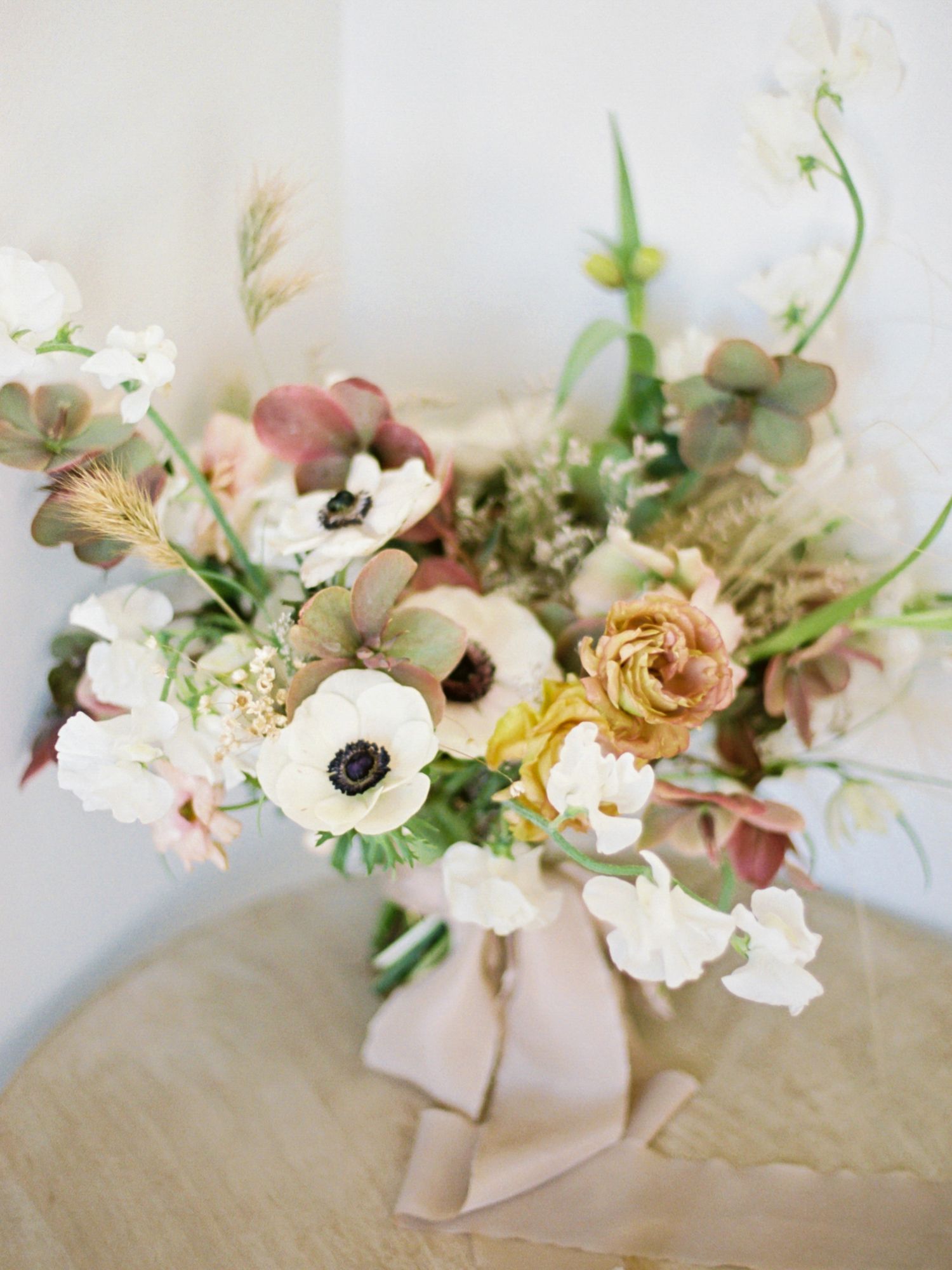 Romantic floral arrangement with anemones and roses in muted pink and white tones at Park Winters.