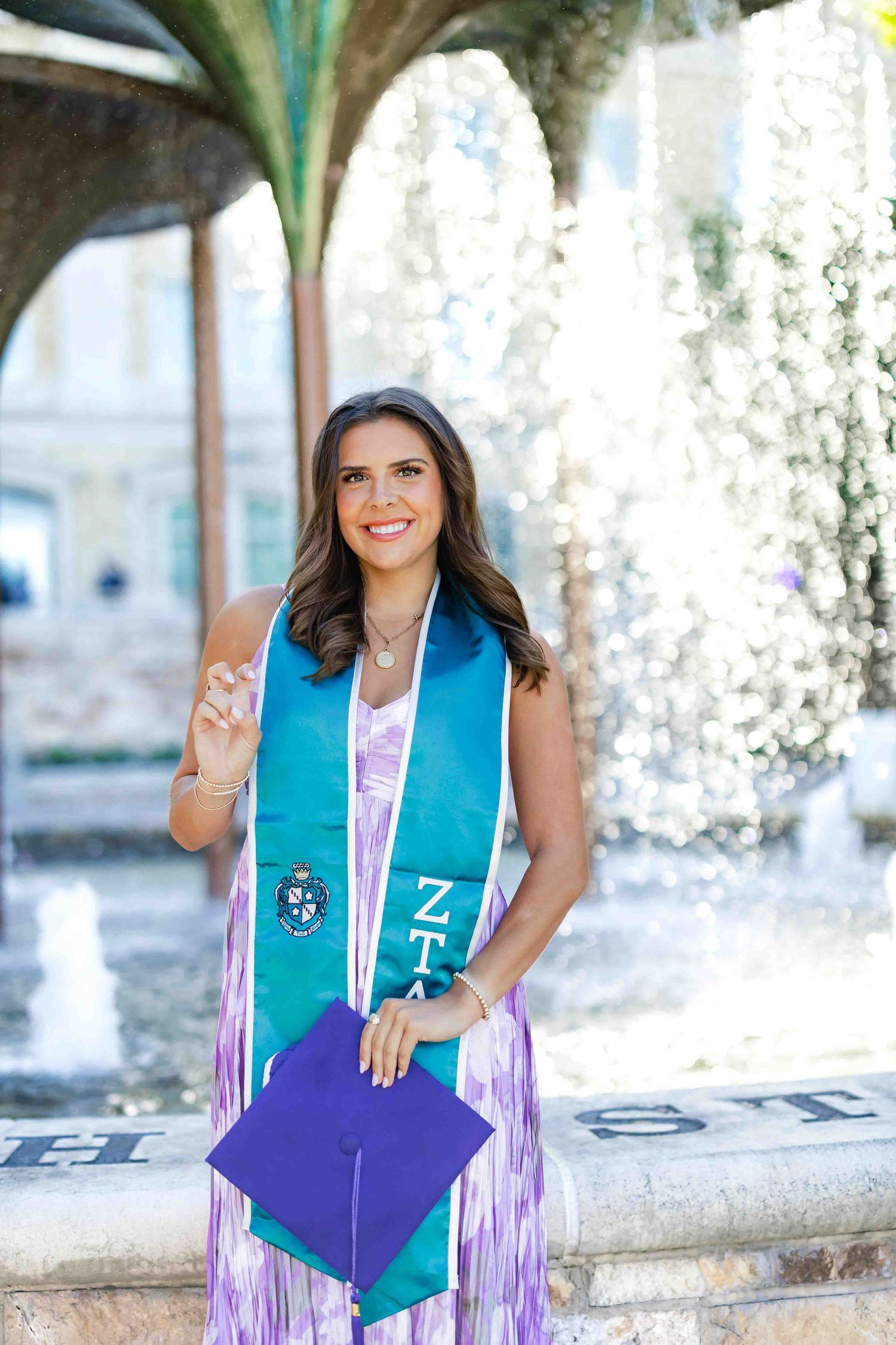 Graduation photos showing colorful academic stoles and decorative tassels outdoors.