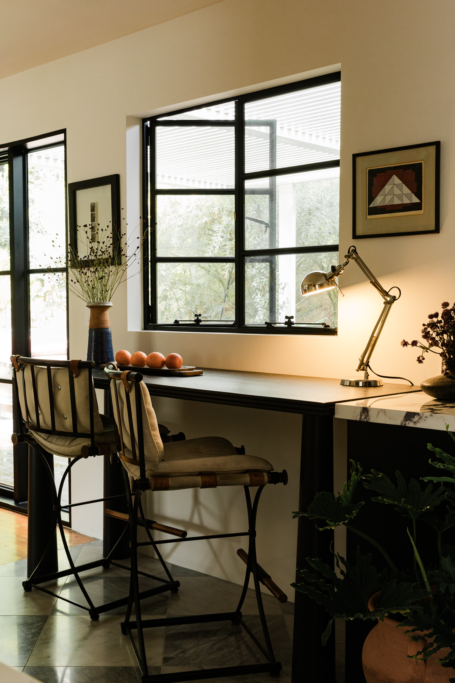 Modern Los Angeles marble kitchen with vintage decor and Pinky's Iron Doors Windows photographed by Kristen Cox