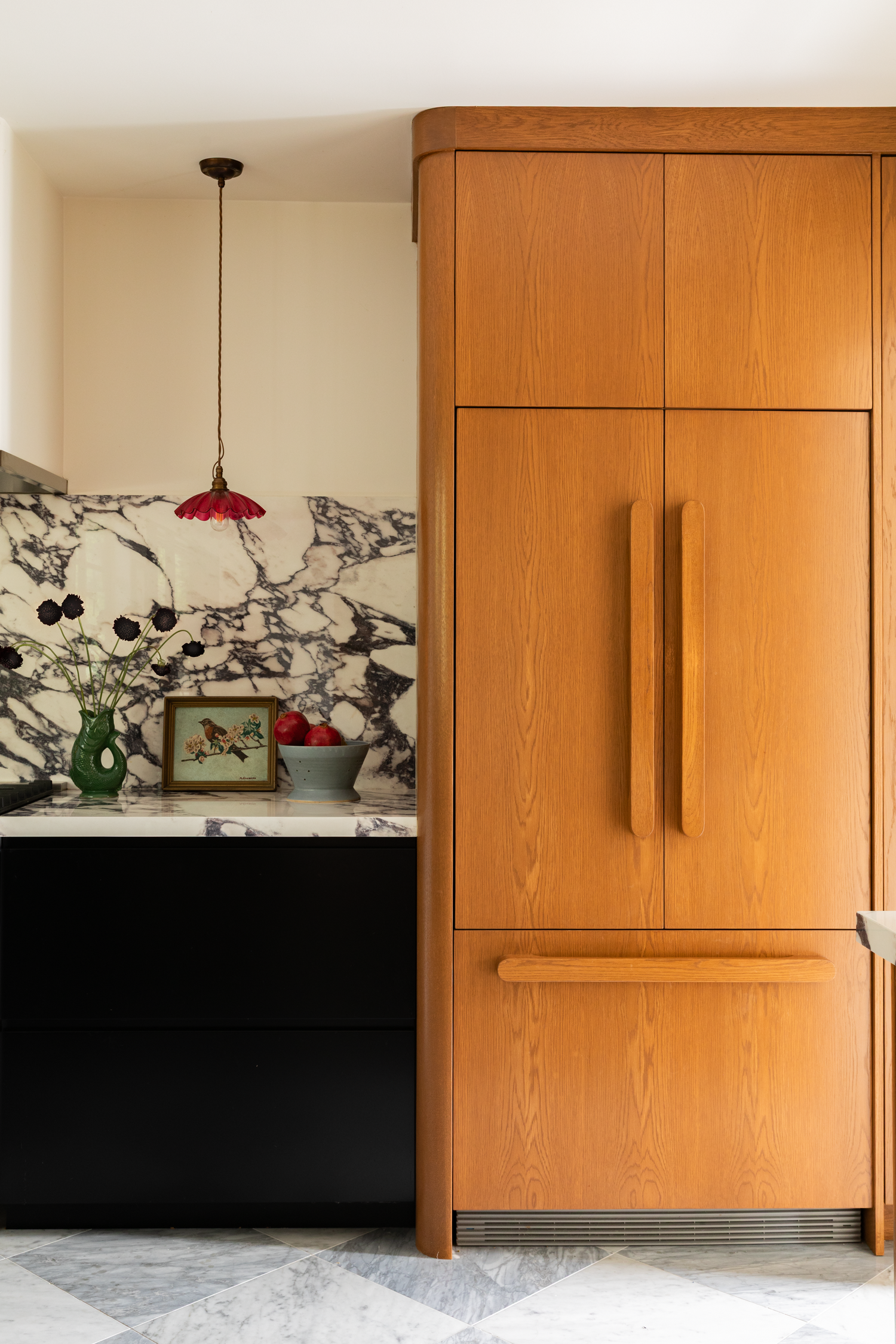 Modern Los Angeles marble kitchen with wood refrigerator designed by Asia Ragland Hall and photographed by Kristen Cox