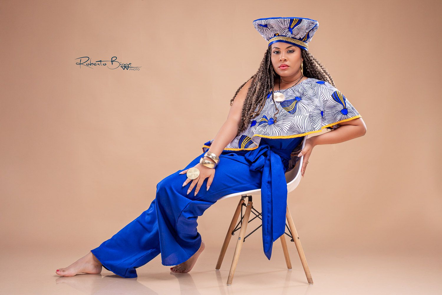 A fashionable royal blue dress with wide sleeves is displayed across multiple poses against a beige backdrop.