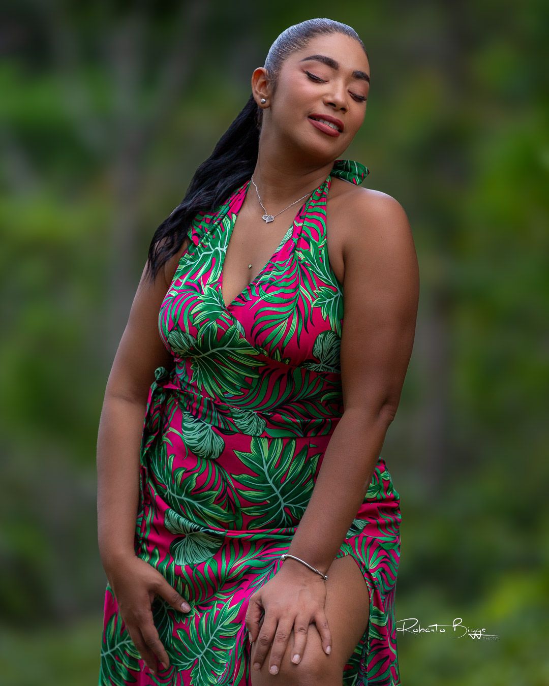 Woman in tropical print dress poses outdoors against lush green background in a series of glamour shots.