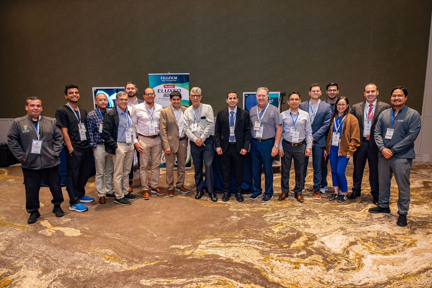 Group of professionals posing together at a business conference in a modern venue.