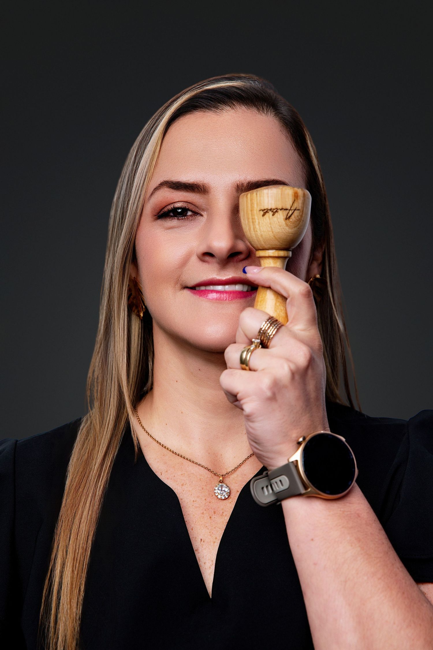 A series of close-up shots showing someone smelling a perfume bottle against a dark background.