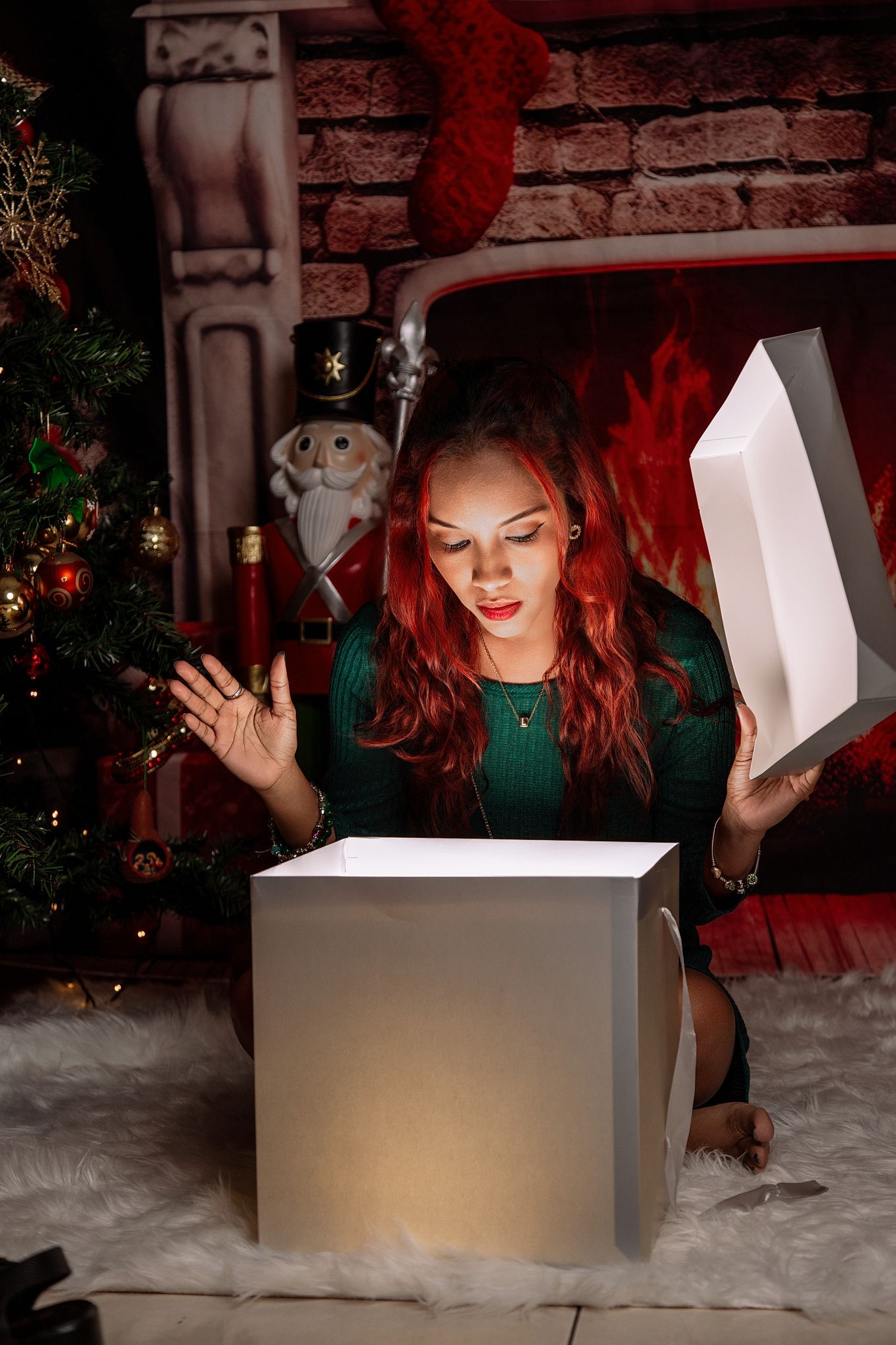 A glowing white gift box emits magical light in a cozy Christmas setting with brick wall and stockings.