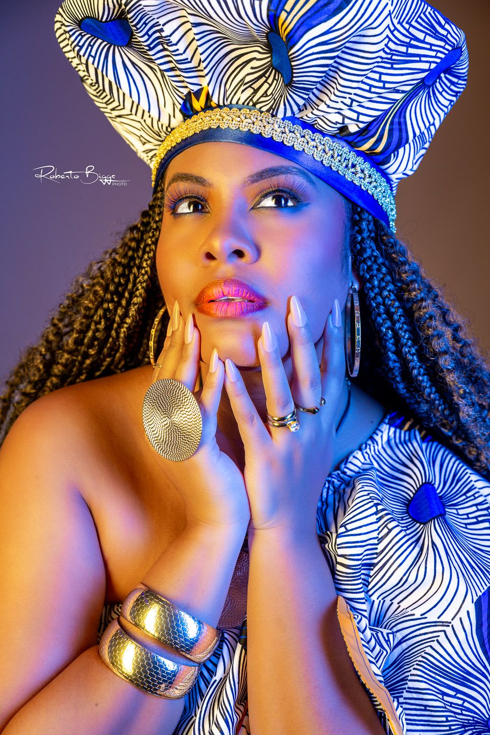 Artistic portrait series featuring blue lighting and a black and white patterned head wrap with gold jewelry accents.