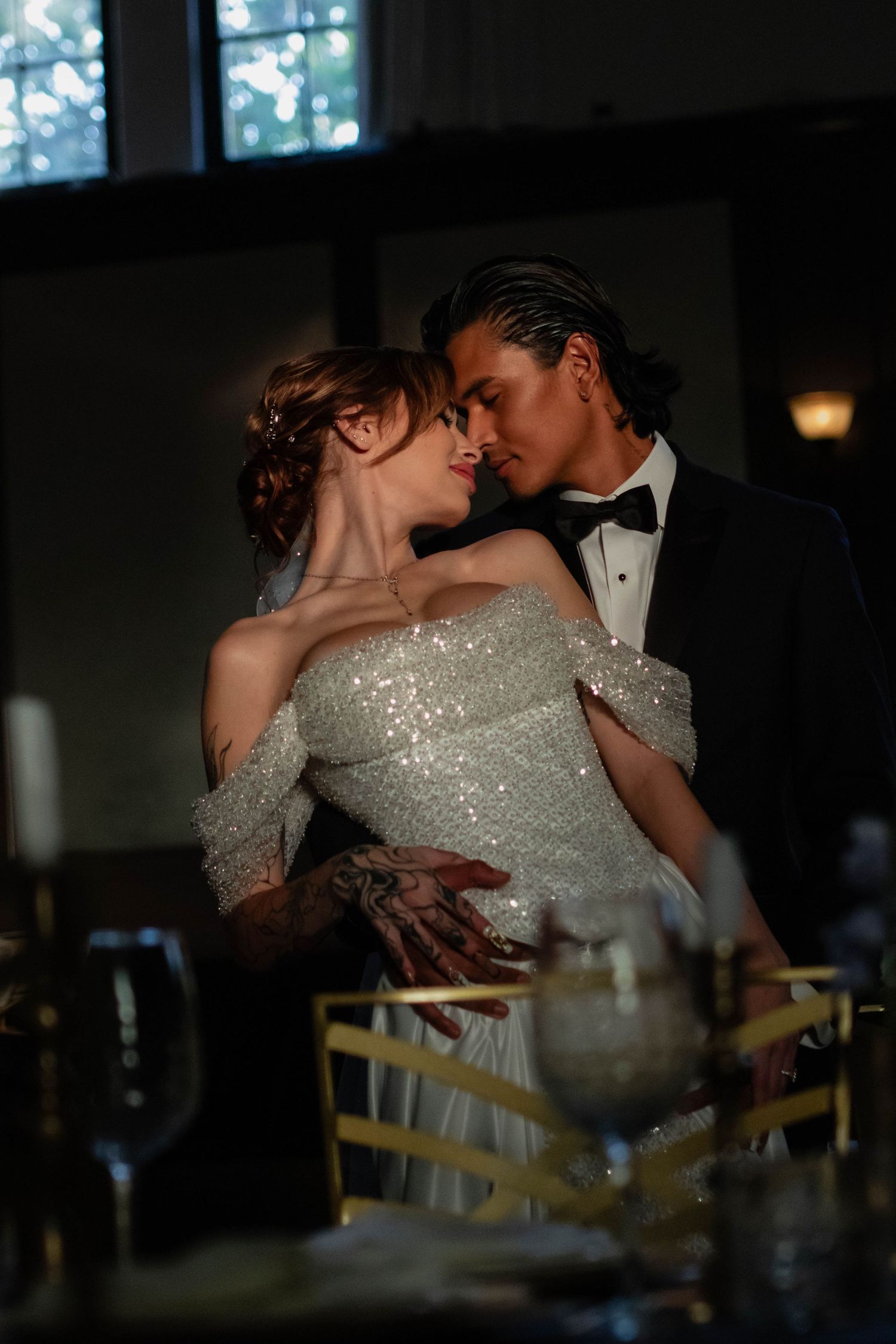 A bride and groom share a romantic moment at their elegant wedding reception.