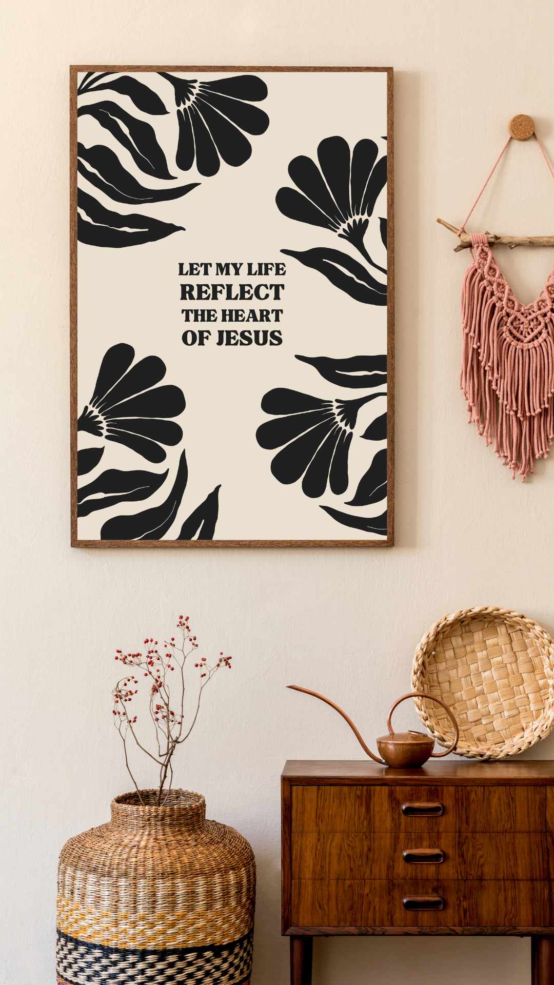 Framed botanical print reading Let my life reflect the heart of Jesus, hung above a wooden console with woven decor.