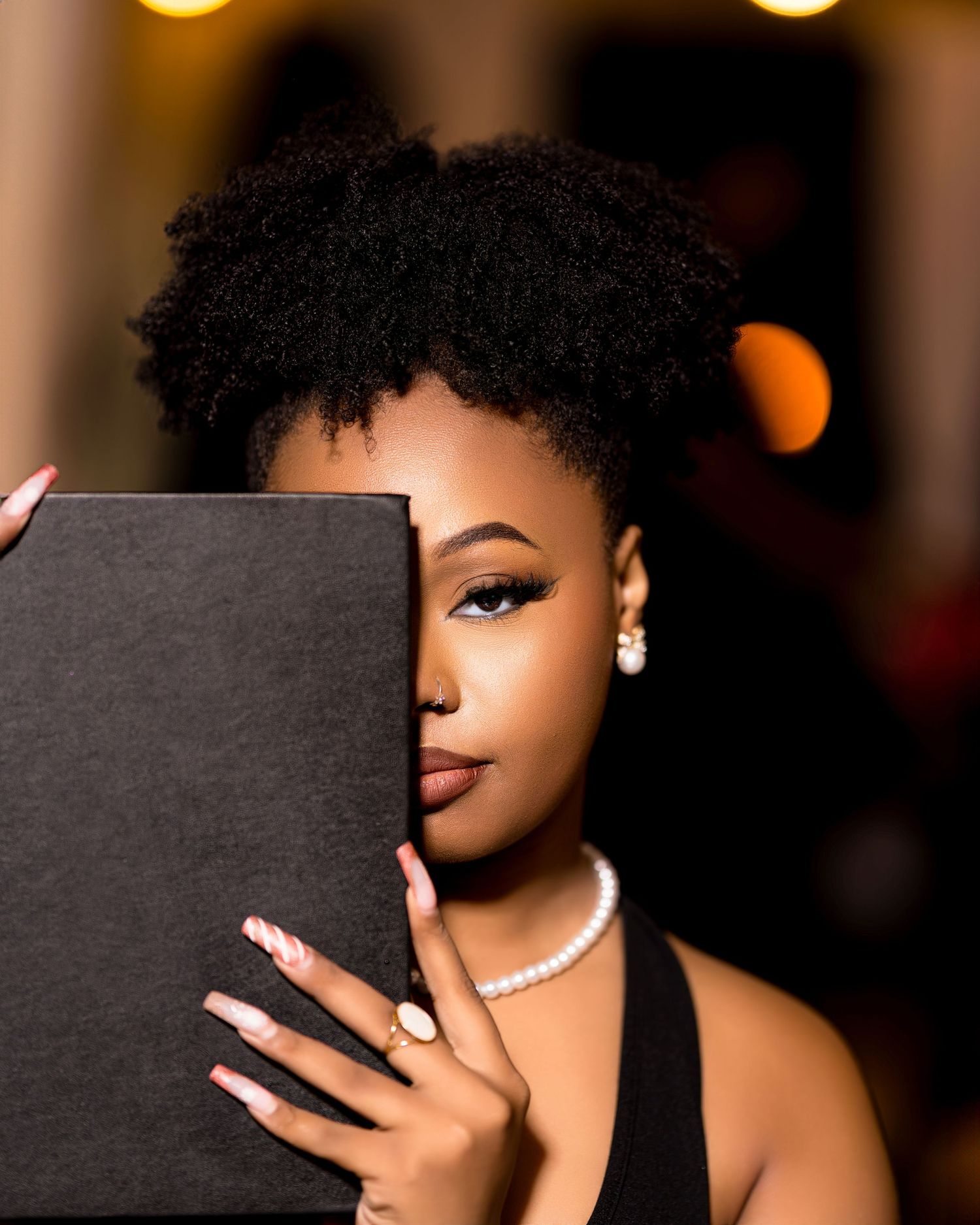 portrait of woman holding black book — minimal creative composition by Timoy B Photography.
