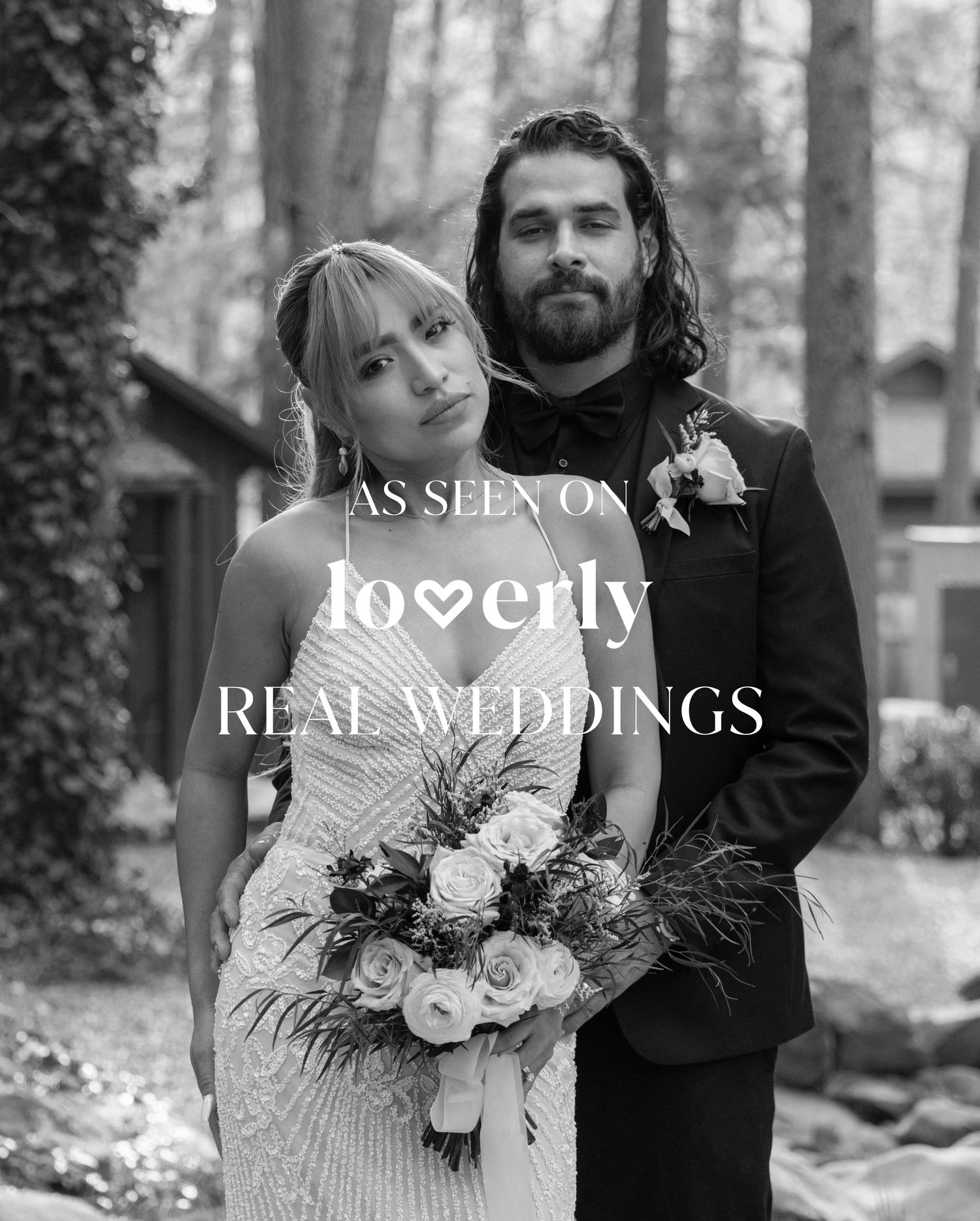 Black and white photo of a bride and groom featured on Loverly Real Weddings, bride holding white roses bouquet.