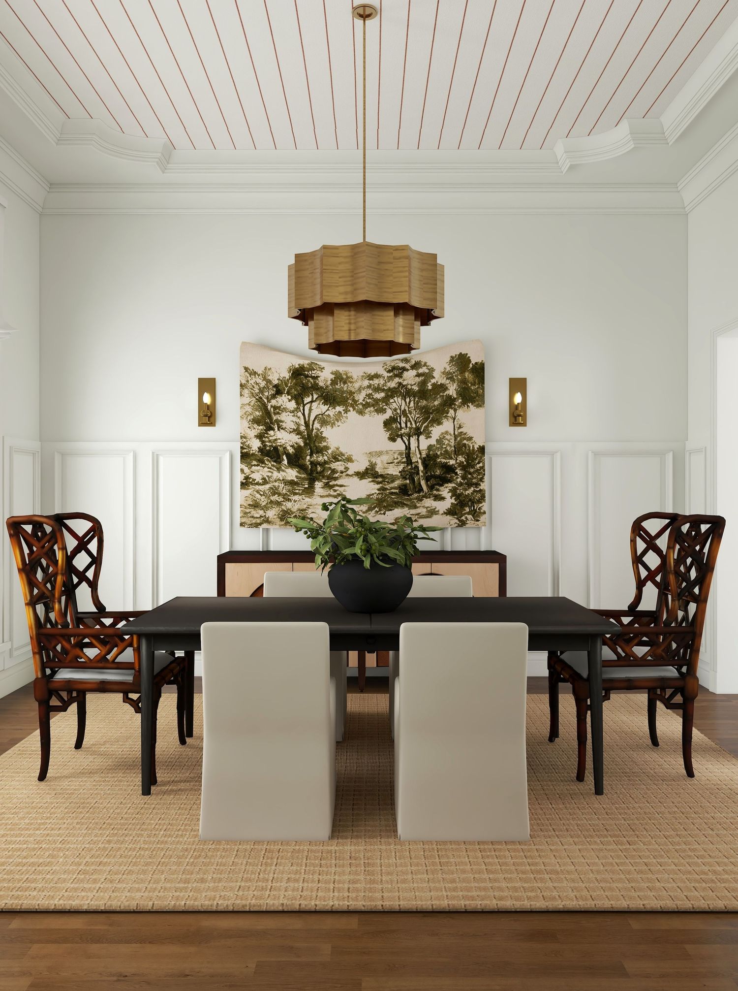 Modern traditional dining room with slipcovered chairs, rattan armchair, black table, vintage landscape art, and warm layered neutrals.