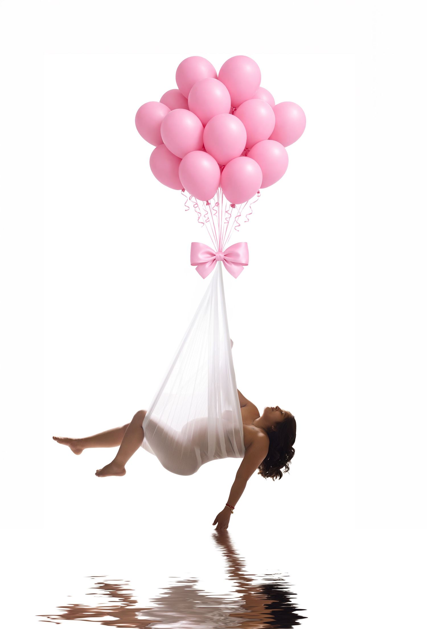 Woman wrapped in white fabric lifted by pink balloons with bow, reflected on water surface, white background.
