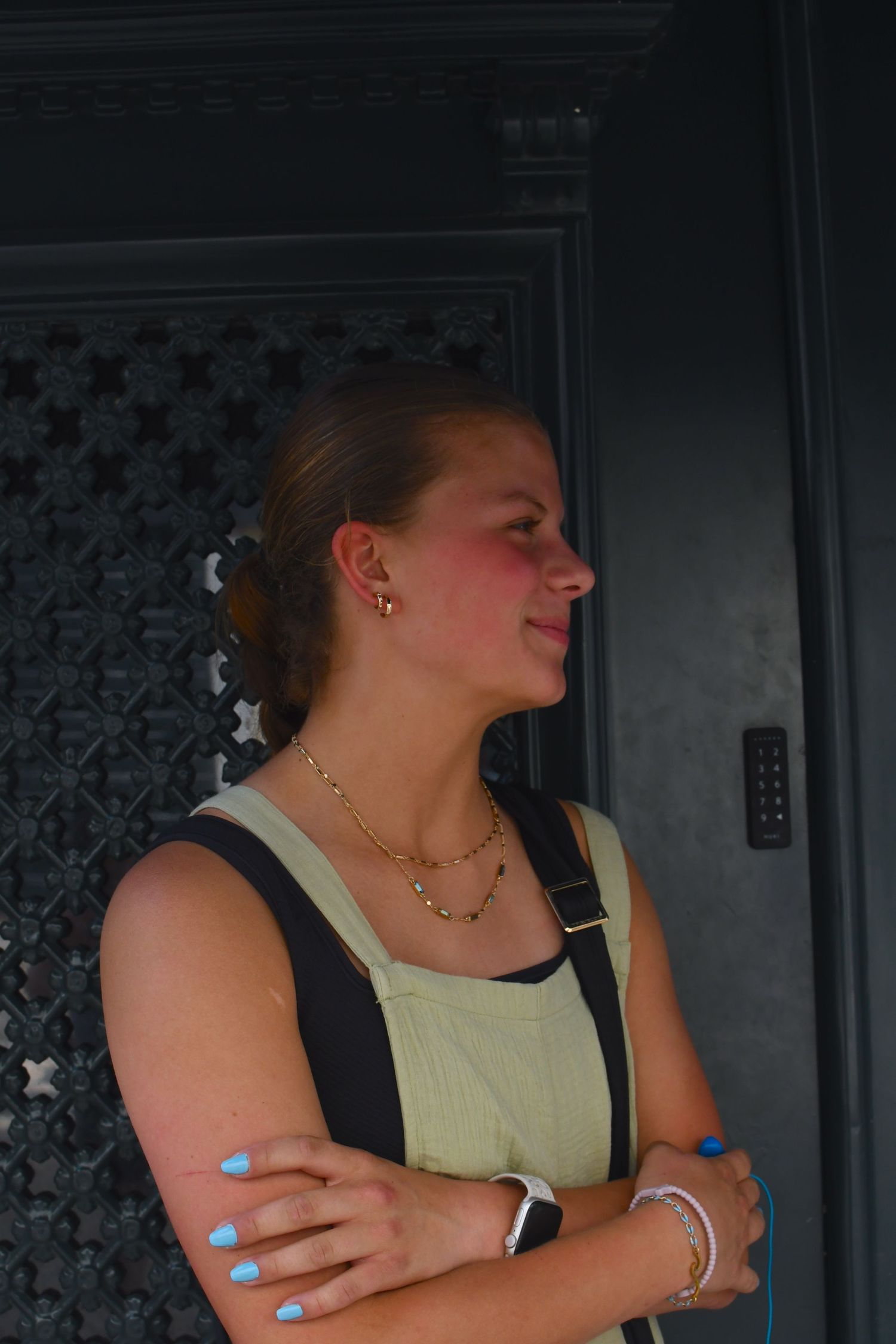 Woman in yellow tank top relaxing in a dimly lit interior setting.
