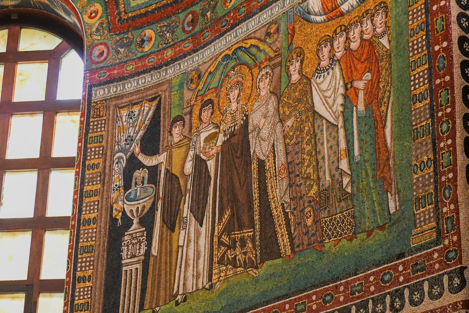 Medieval mosaic wall art showing religious scenes with elaborate golden details.