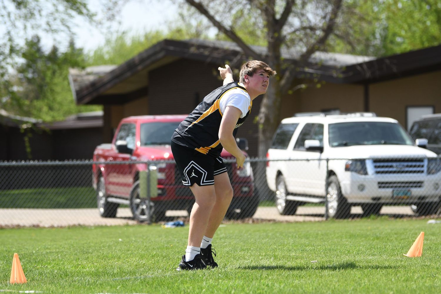 Track athlete winds up for discus throw competition.