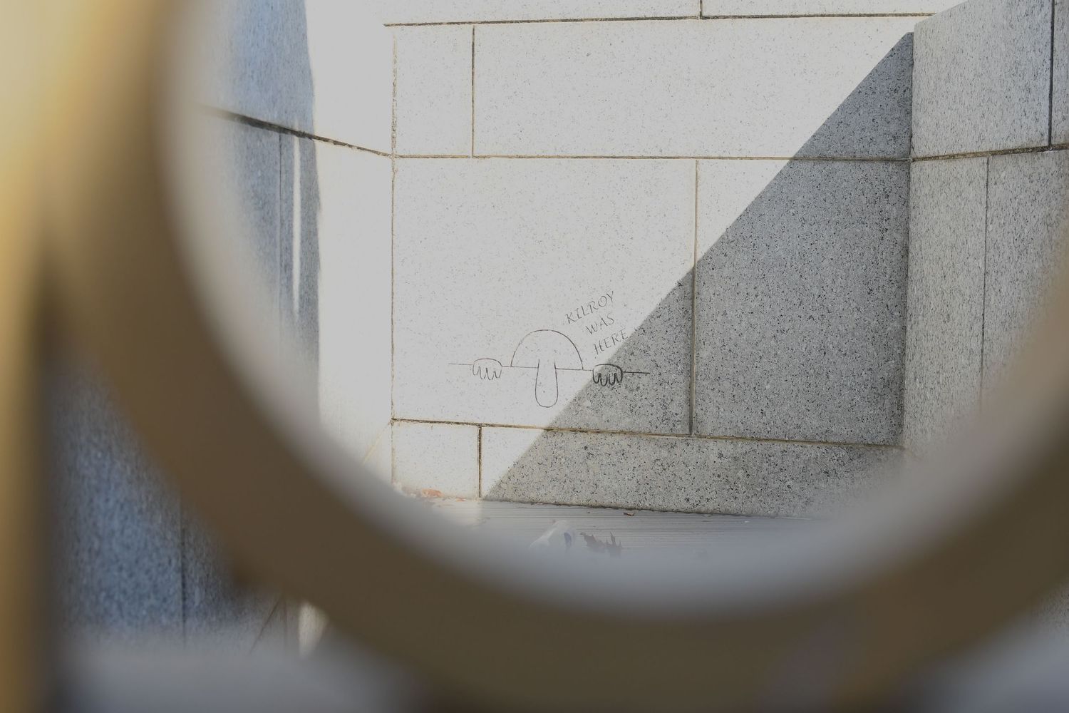 Close-up view of white brick wall texture seen through a circular frame.