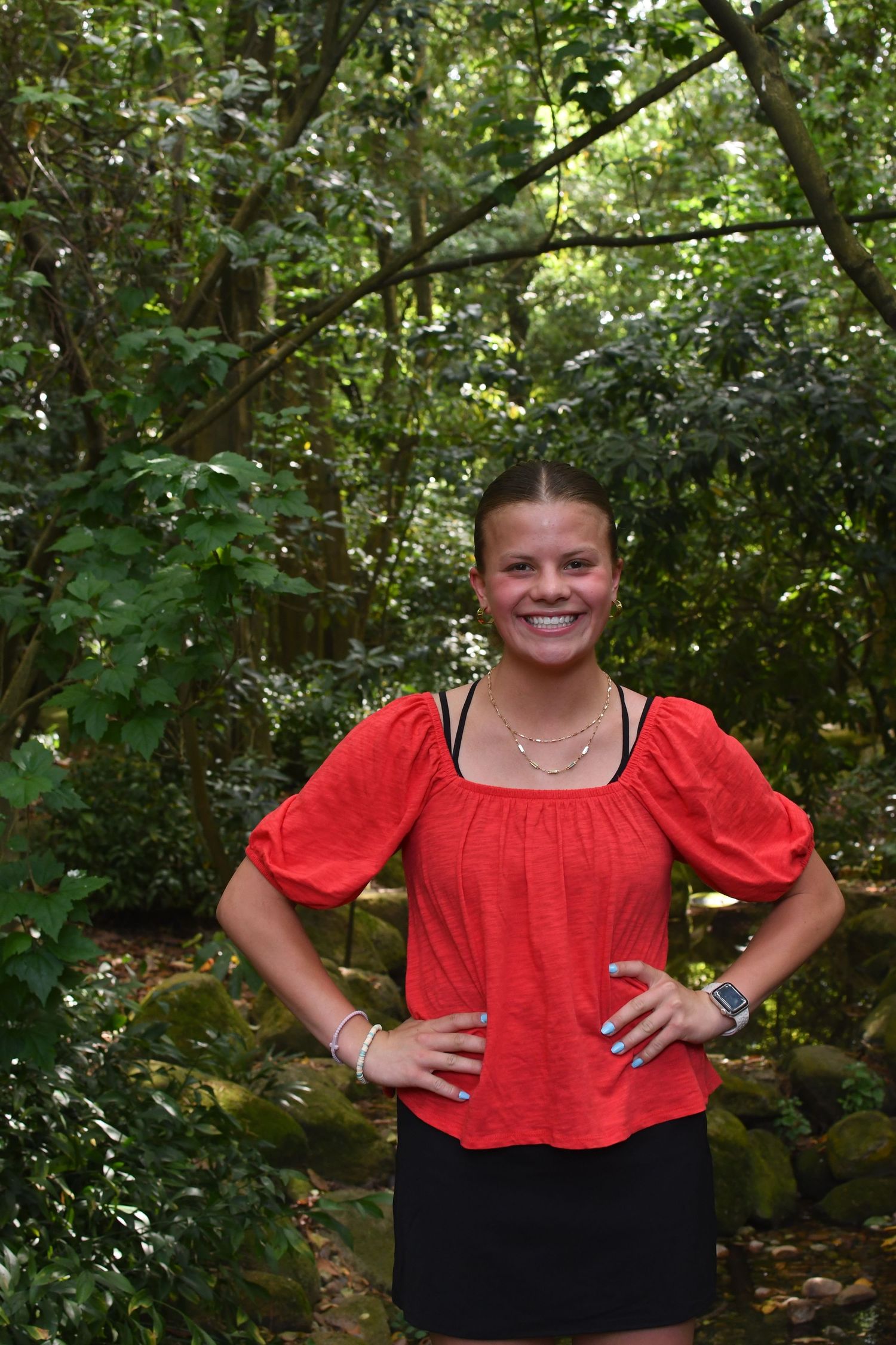 A series of outdoor portraits with someone wearing a red puff-sleeve top against green foliage.