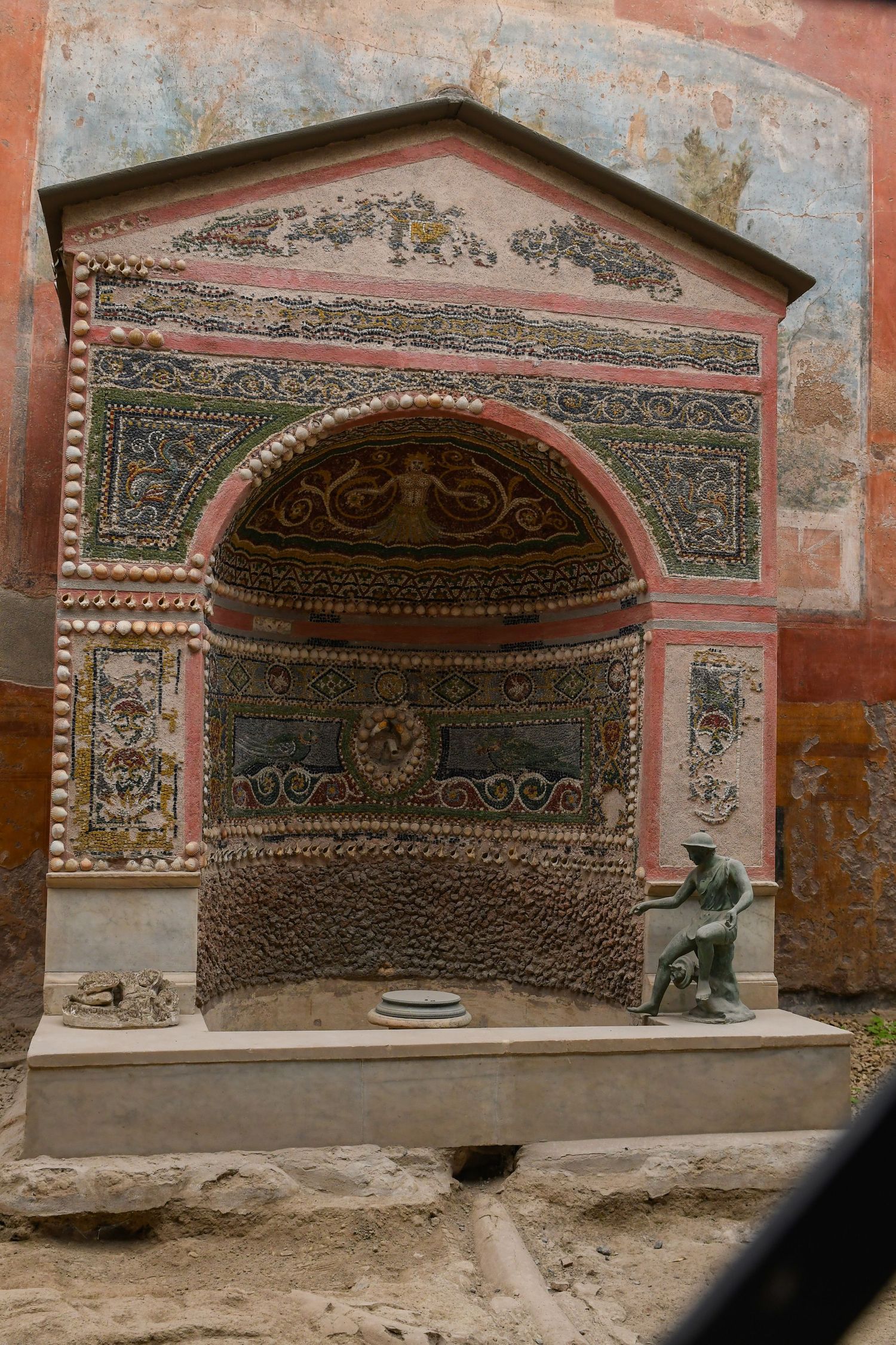 Decorative wall niches with intricate patterns and designs in ancient Roman architecture.