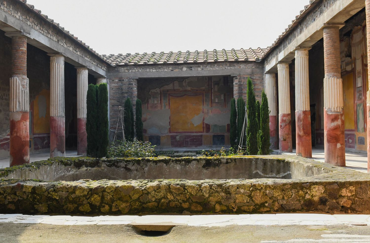 Ancient Roman courtyard with columns and peristyle architecture in ruins.