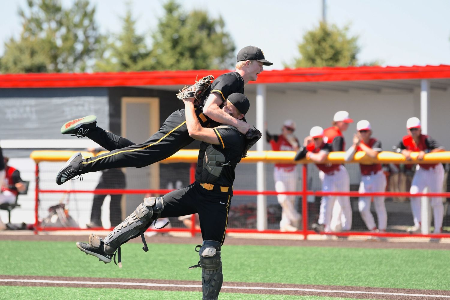 Baseball player makes a diving catch attempt while fully extended in the air.