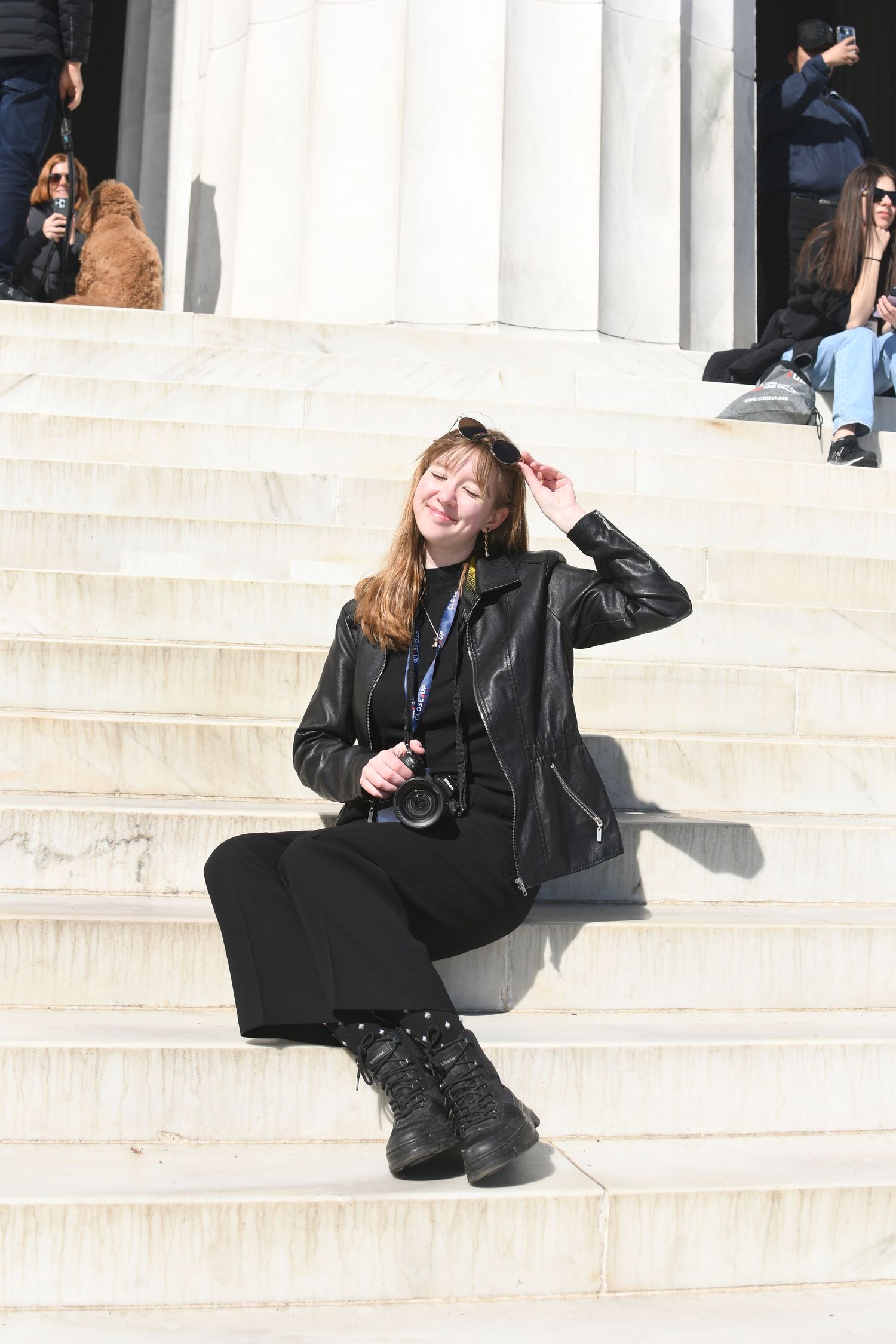 A series of photos showing someone lounging casually on white marble steps in the sunlight.