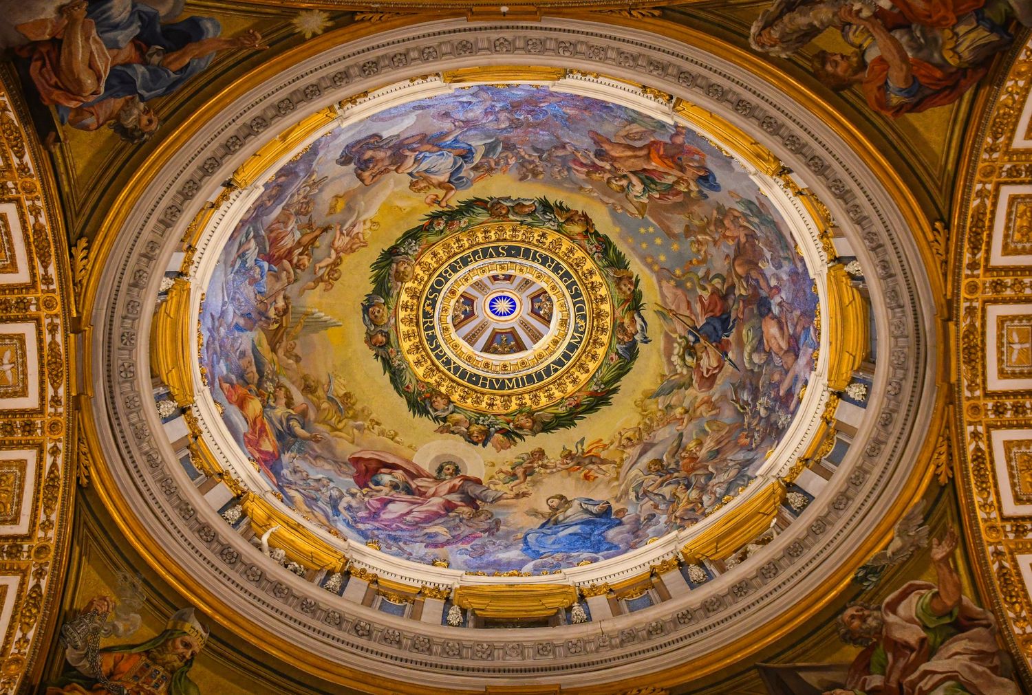 Baroque church dome interior with elaborate frescoes and ornate gilded decorations.