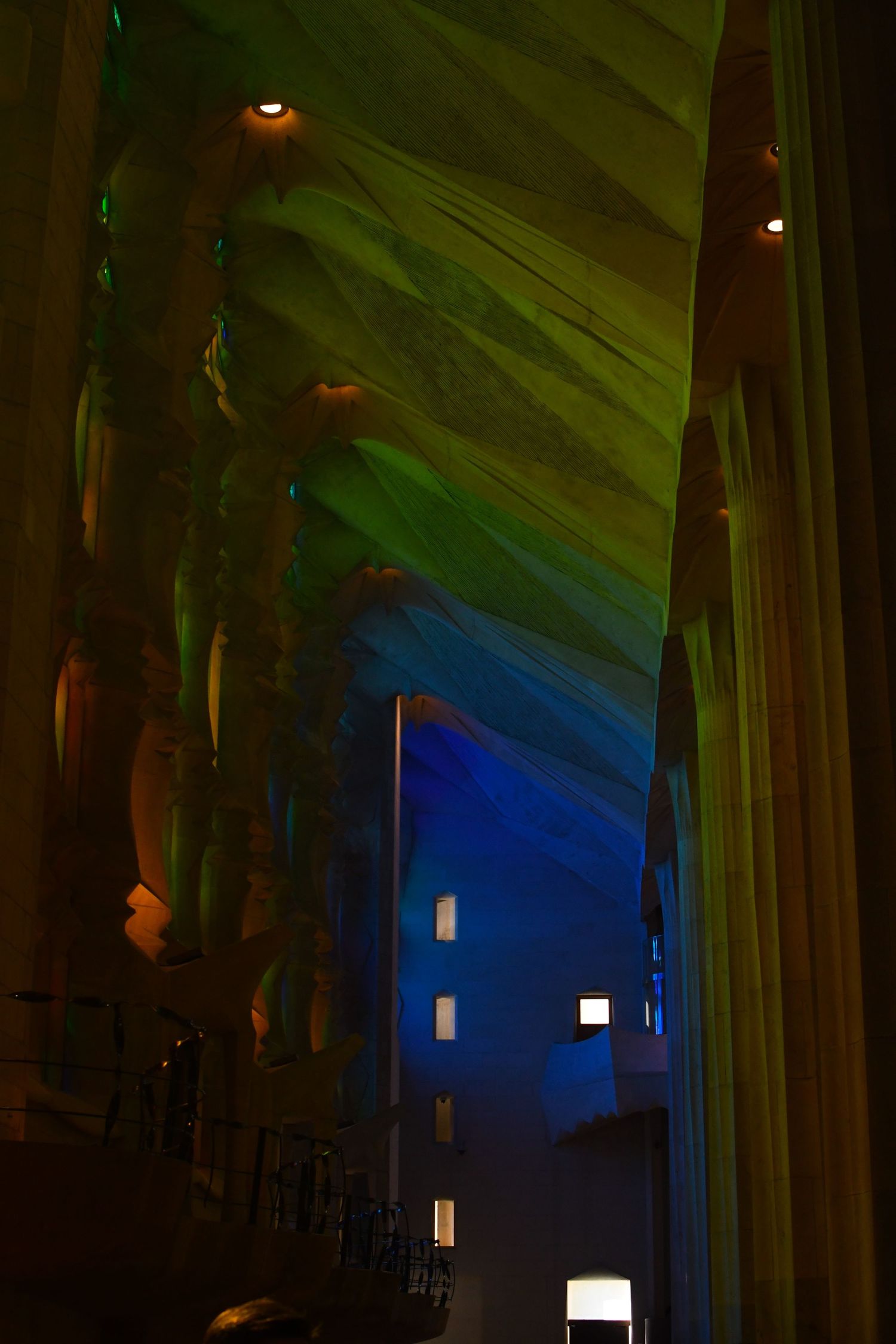 Dramatic green and blue lighting effects in a cathedral interior creating an ethereal atmosphere.
