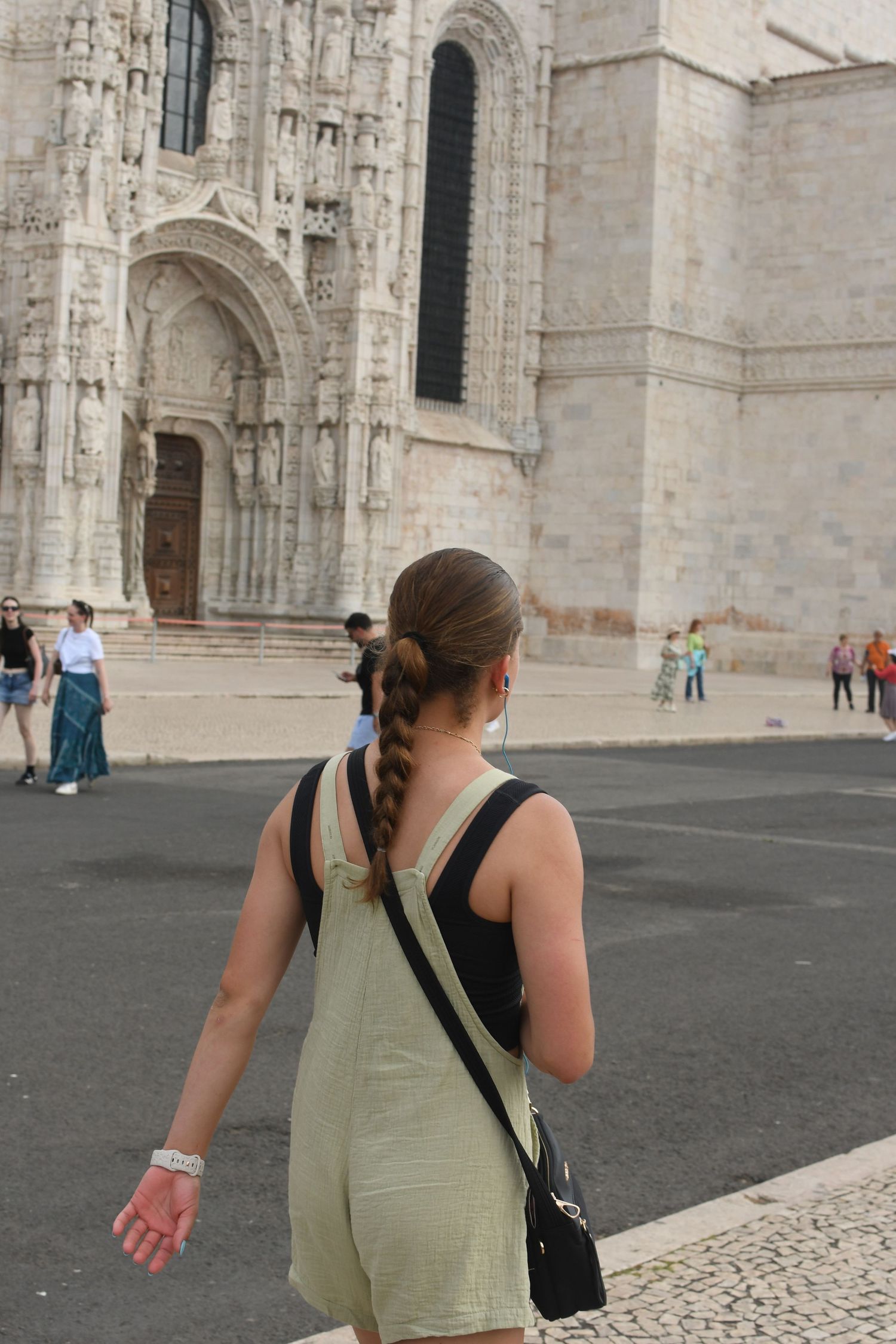 A sequence showing someone walking past an ornate gothic cathedral facade.