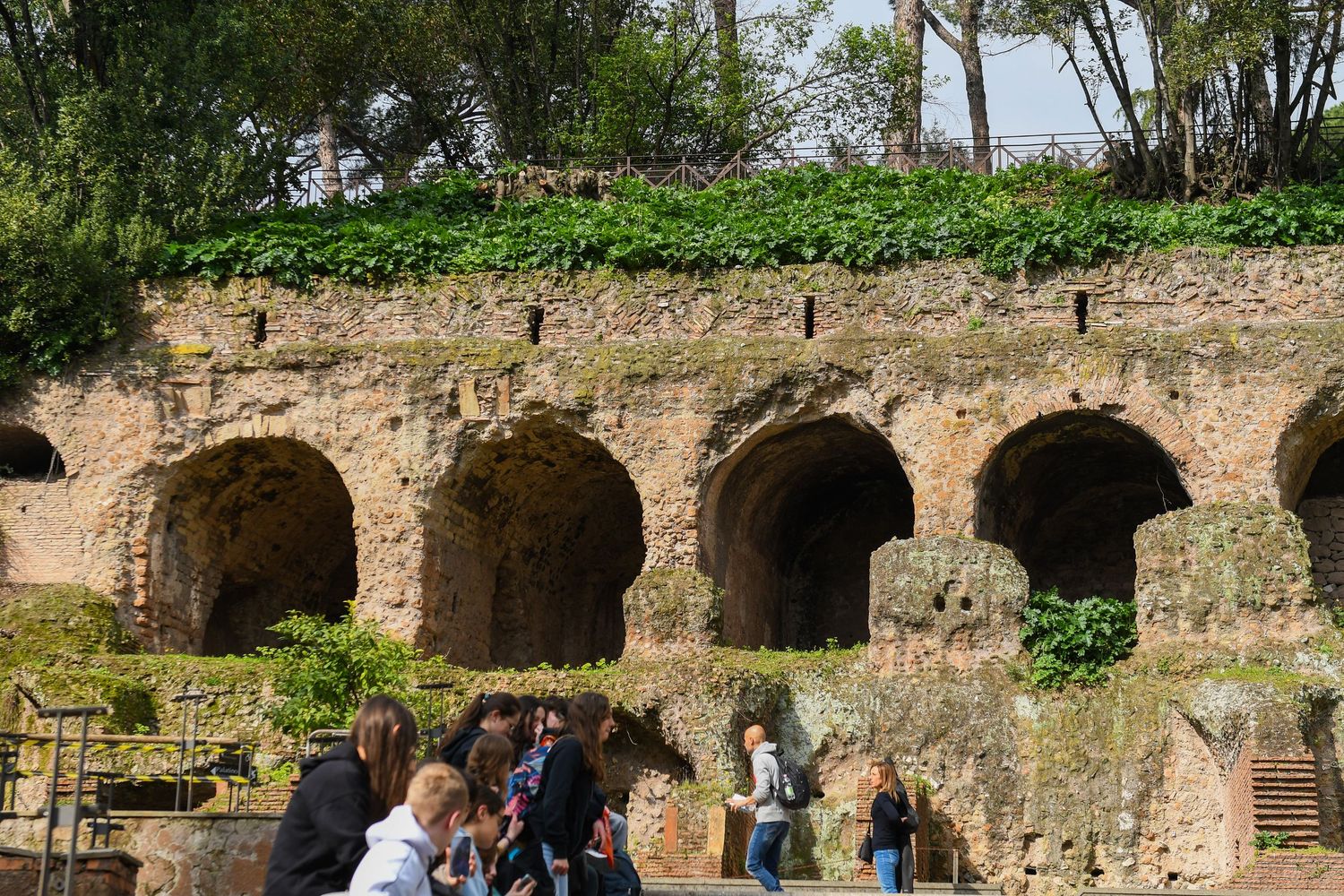 Historic stone archways and ruins in a Mediterranean garden setting.