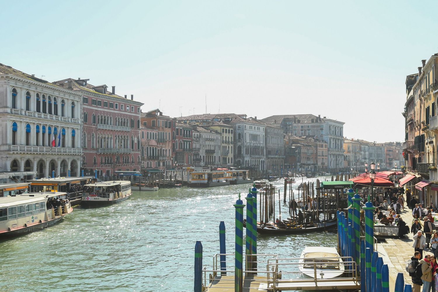 View of Venice's Grand Canal with historic buildings and boats along the waterway during daytime.