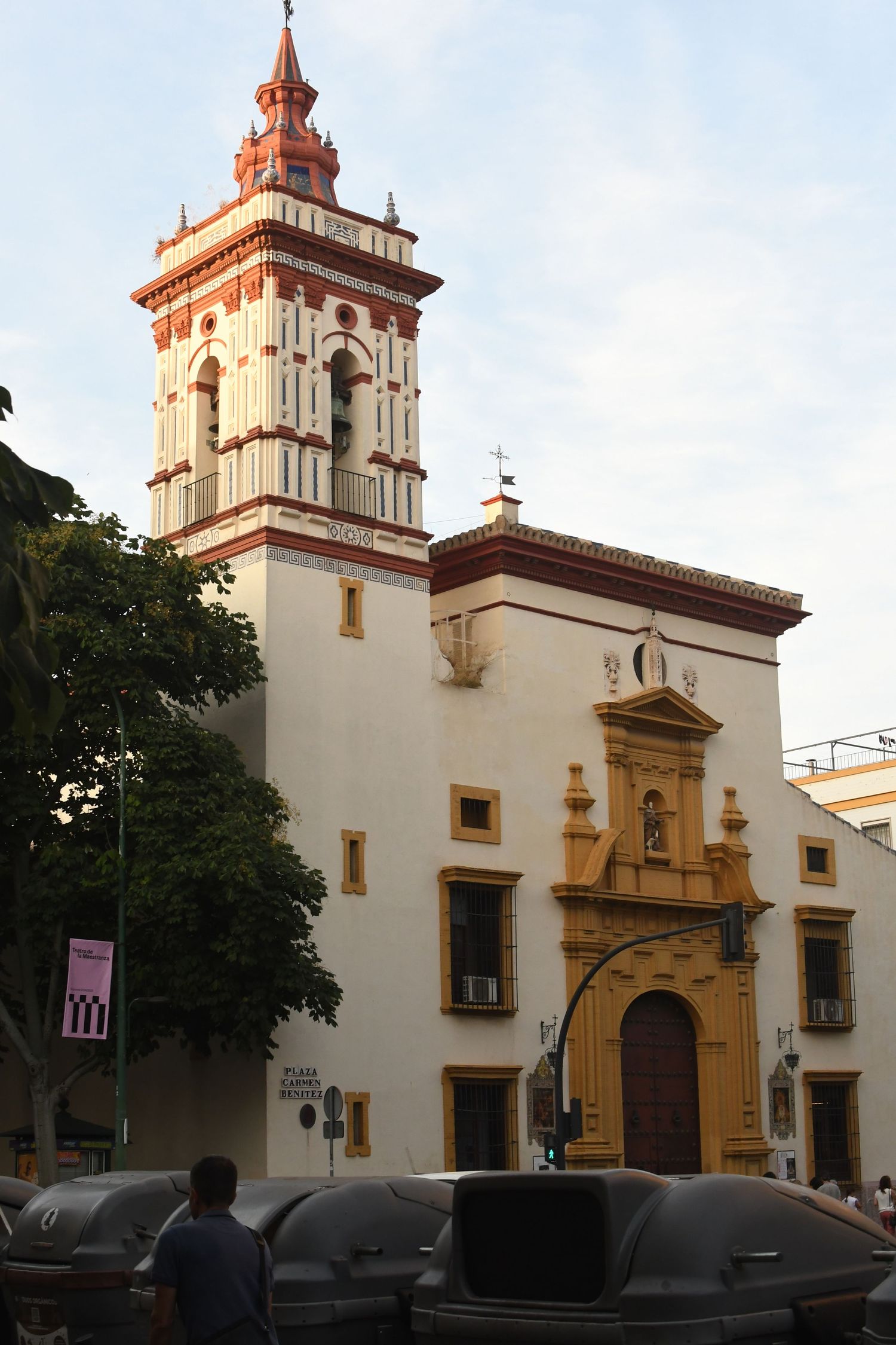 White and ochre colonial church facade with bell tower and arched entrance.