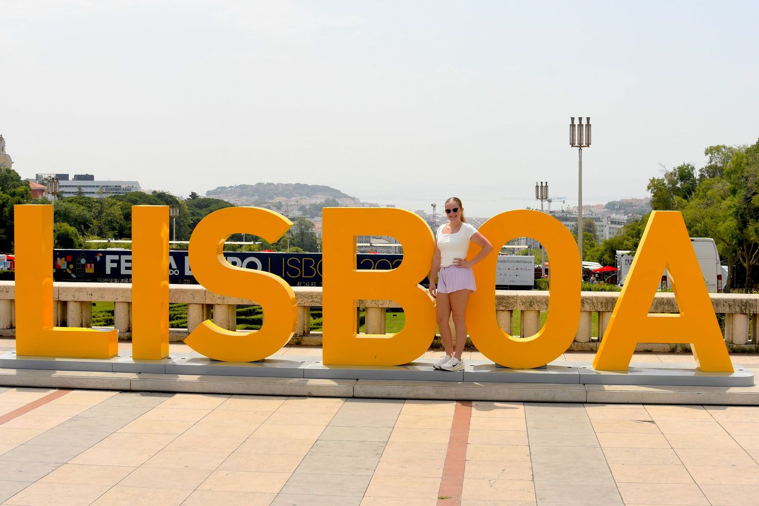 Large orange letters spelling LISBOA against a scenic backdrop create an eye-catching tourist photo spot.