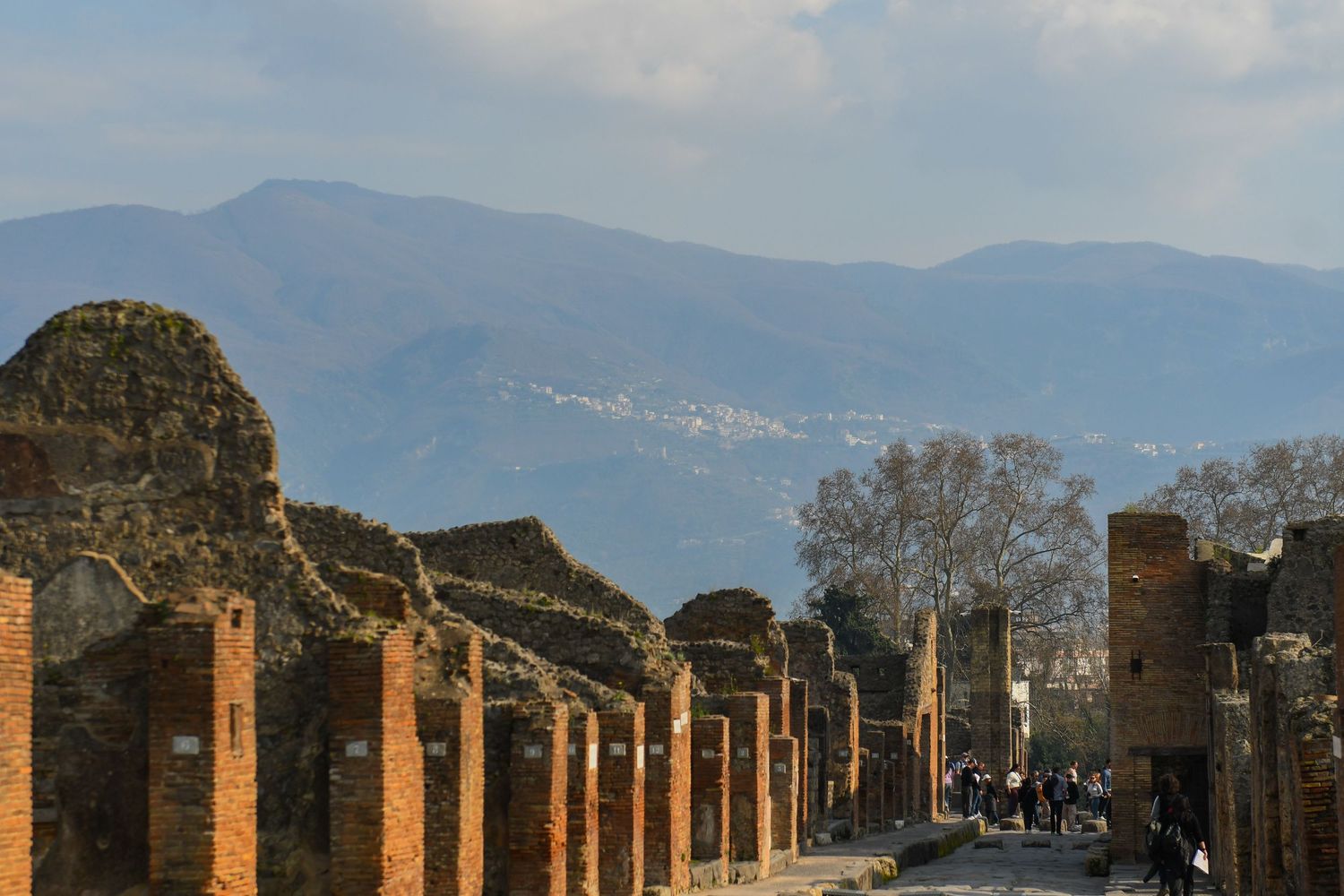 Ancient Roman ruins of Pompeii with Mount Vesuvius visible in the background.