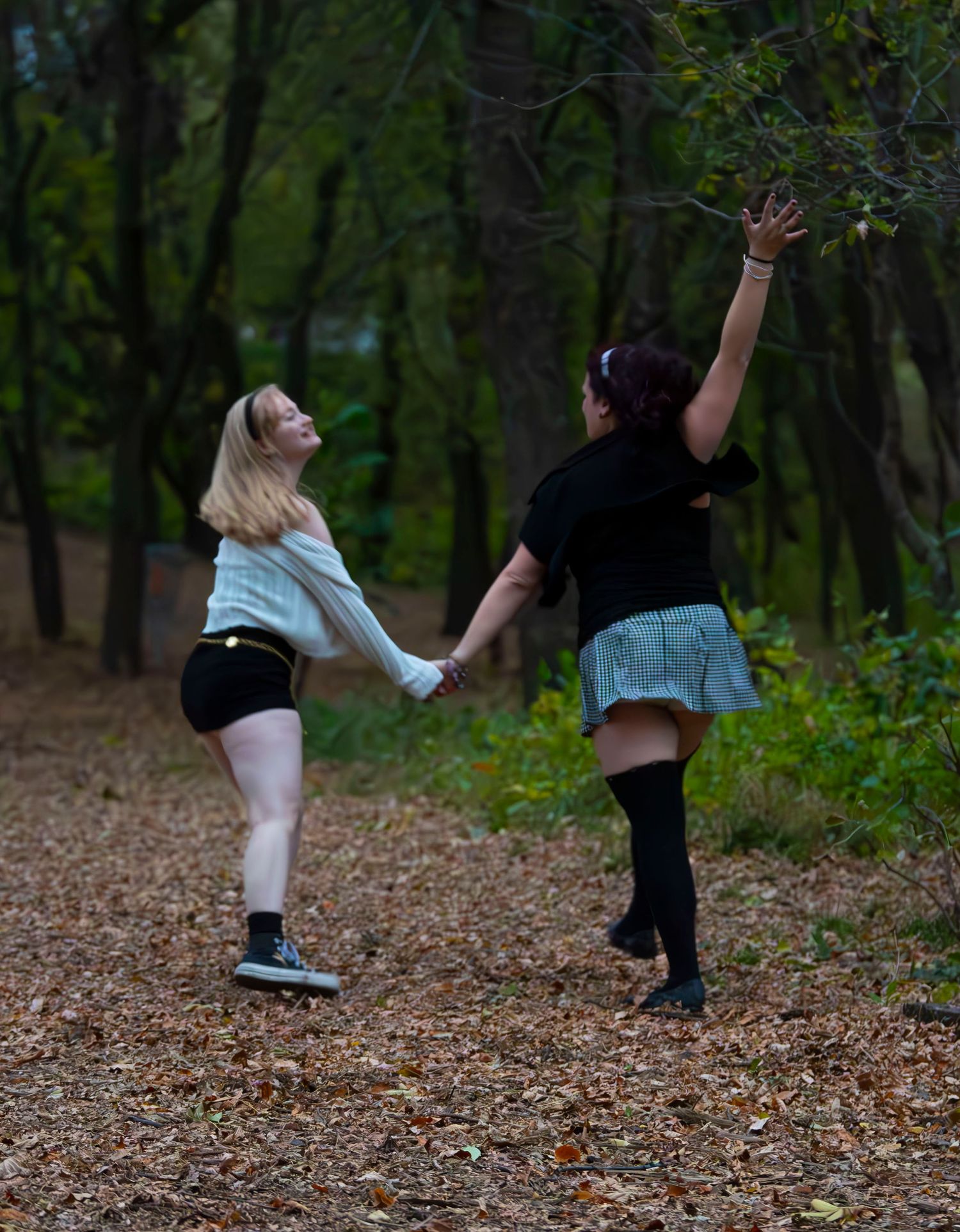 A sequence of dance movements captured in autumn, showing legs and feet kicking through fallen leaves in a wooded area.