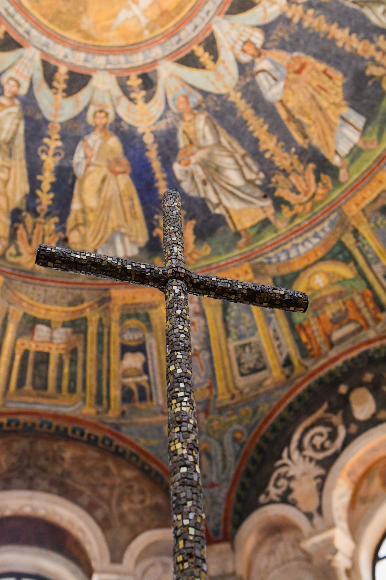 Ancient mosaic ceiling depicting religious figures and ornate patterns in gold and blue tones.
